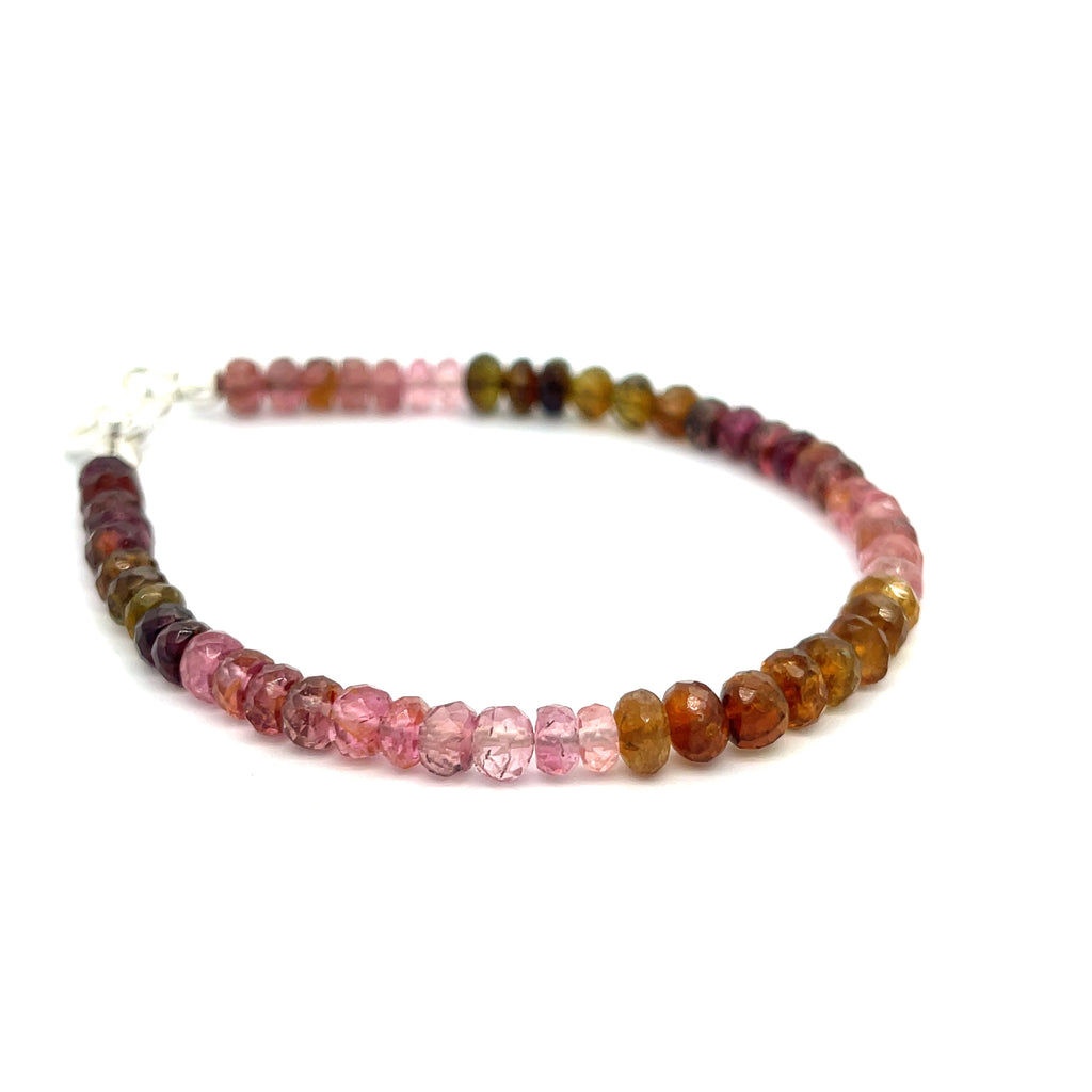 #1 of beaded bracelets featuring tourmaline gemstones in various shades of pink, brown, and green, with sterling silver accents and a silver toggle on a white background, front overview.