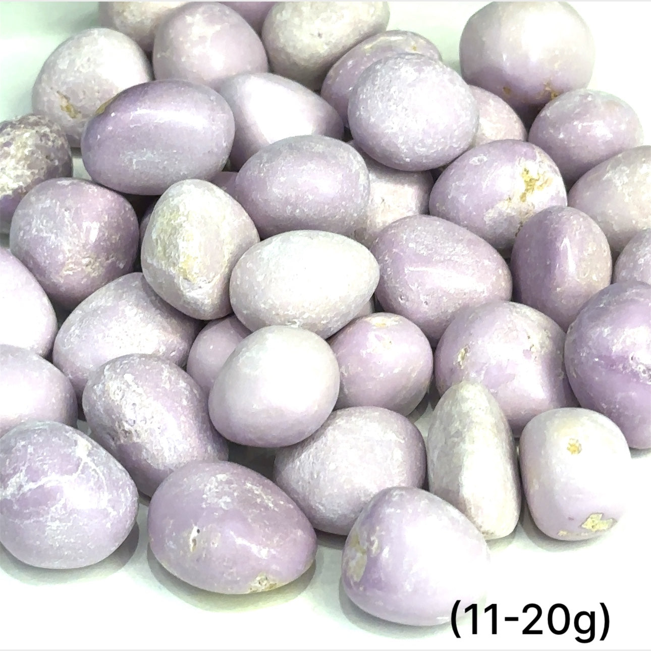 Tumbled Phosphosiderite gemstone in lavender tones on white background sizes (11-20g) overview