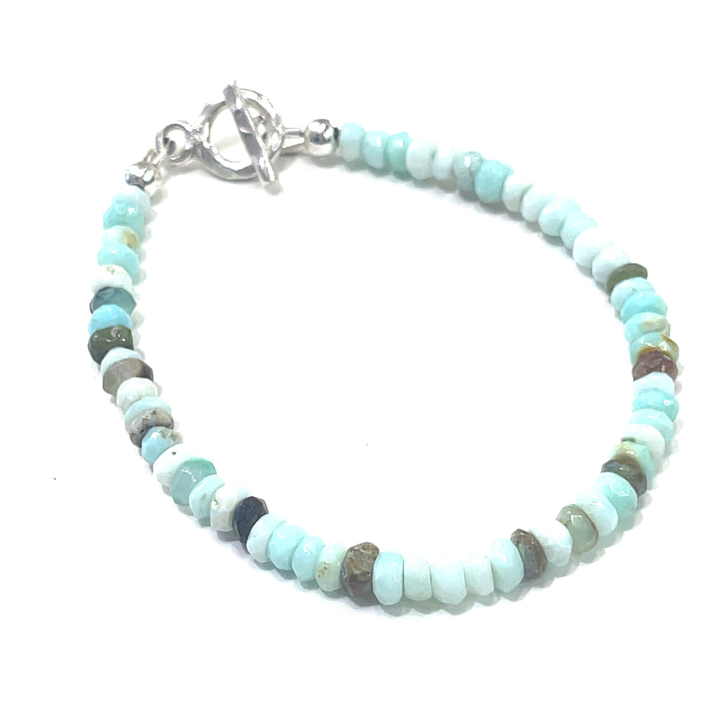 #2  Blue Opal gemstone bracelet with sterling silver toggle handmade by Hidden Jewel on a white background slight right angled overview.