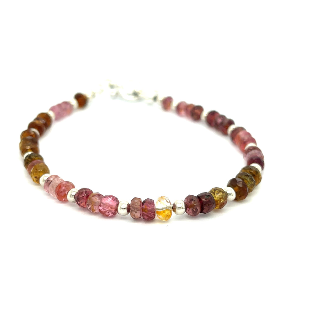 #3 of beaded bracelets featuring tourmaline gemstones in various shades of pink, brown, and green, with sterling silver accents and a silver toggle on a white background, front overview.
