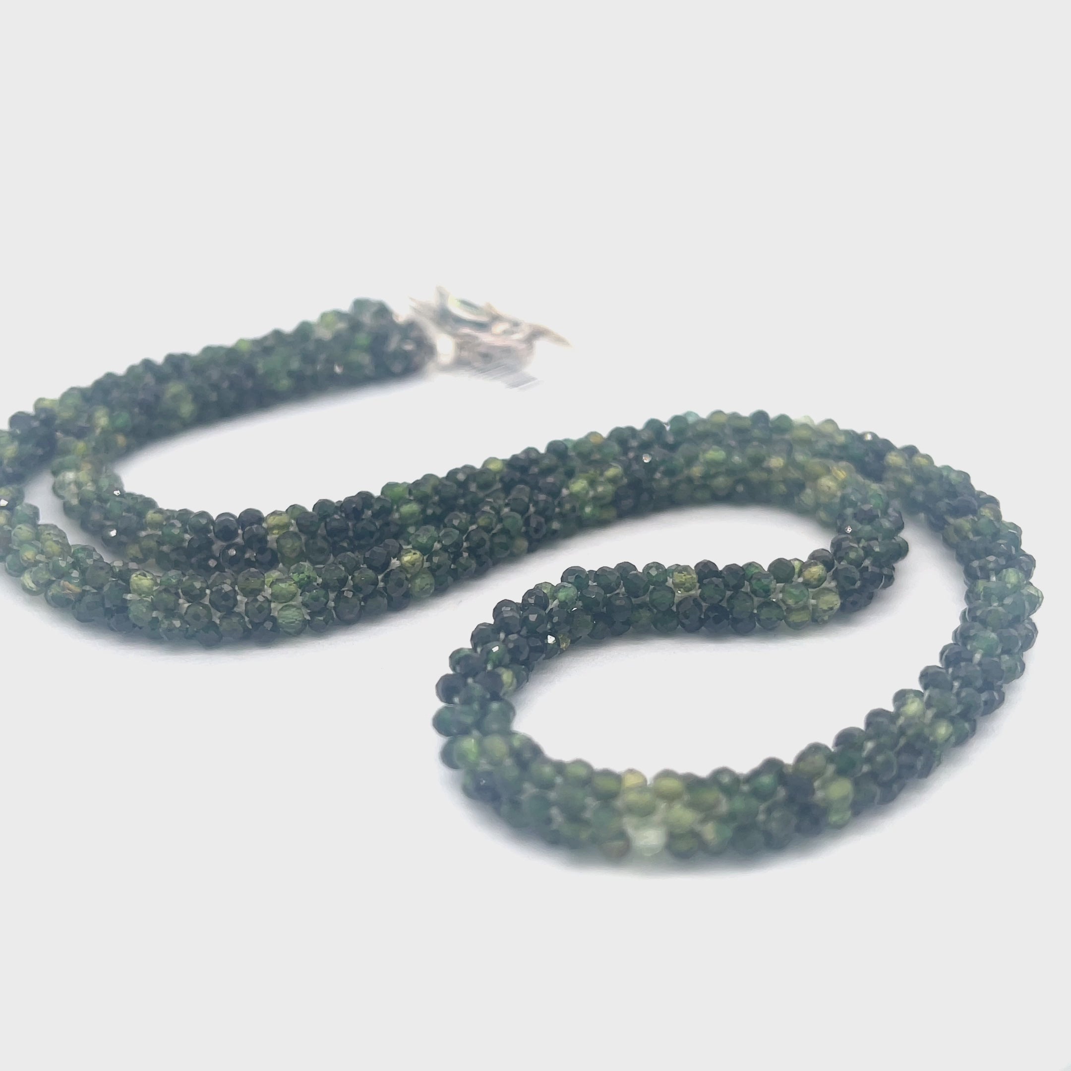 Emerald necklace styled for elegance and everyday wear – a timeless statement of love and abundance. on a white background long, center, toggle overview.  video