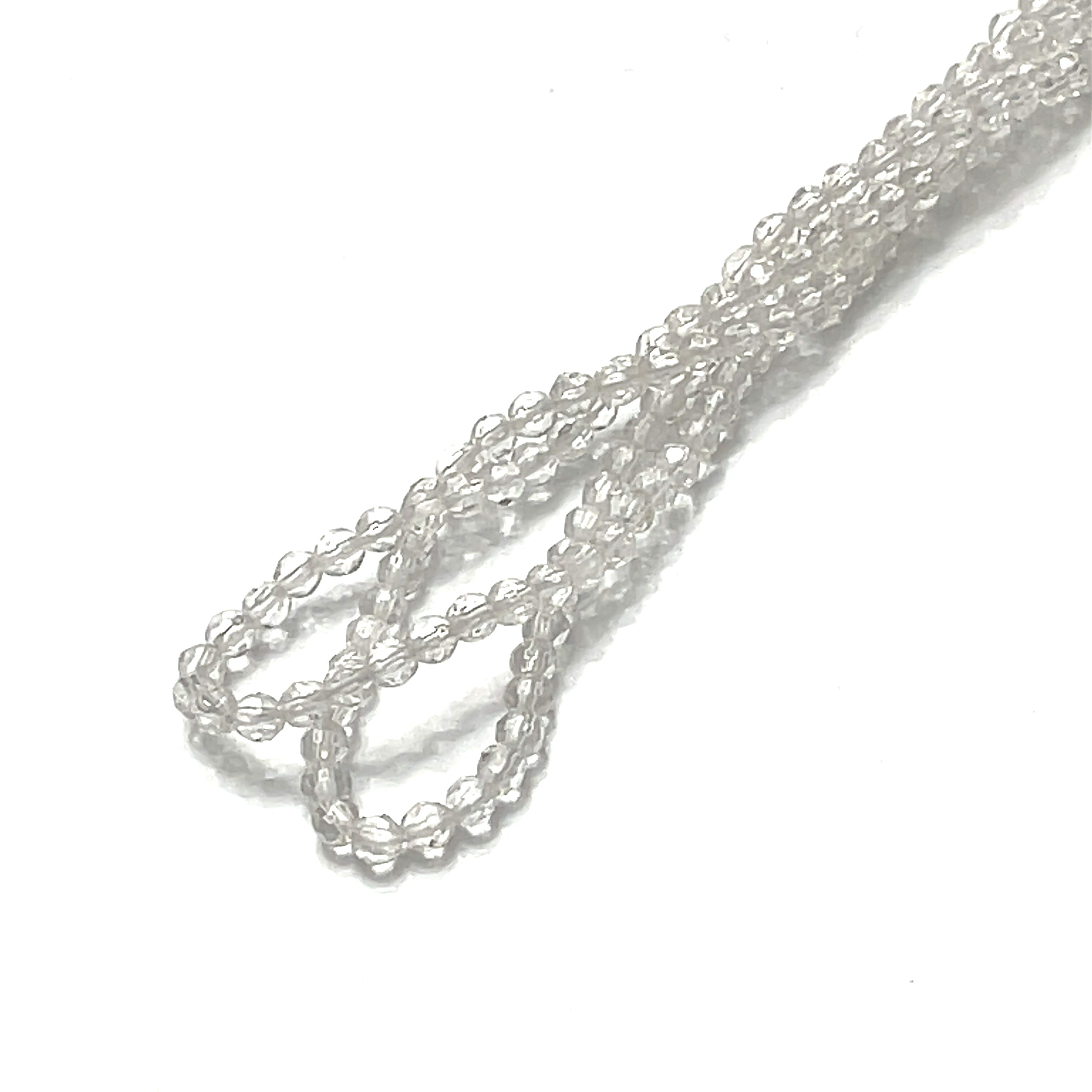 3mm Clear Quartz gemstone micro faceted rounds strand on a white background, overview. 