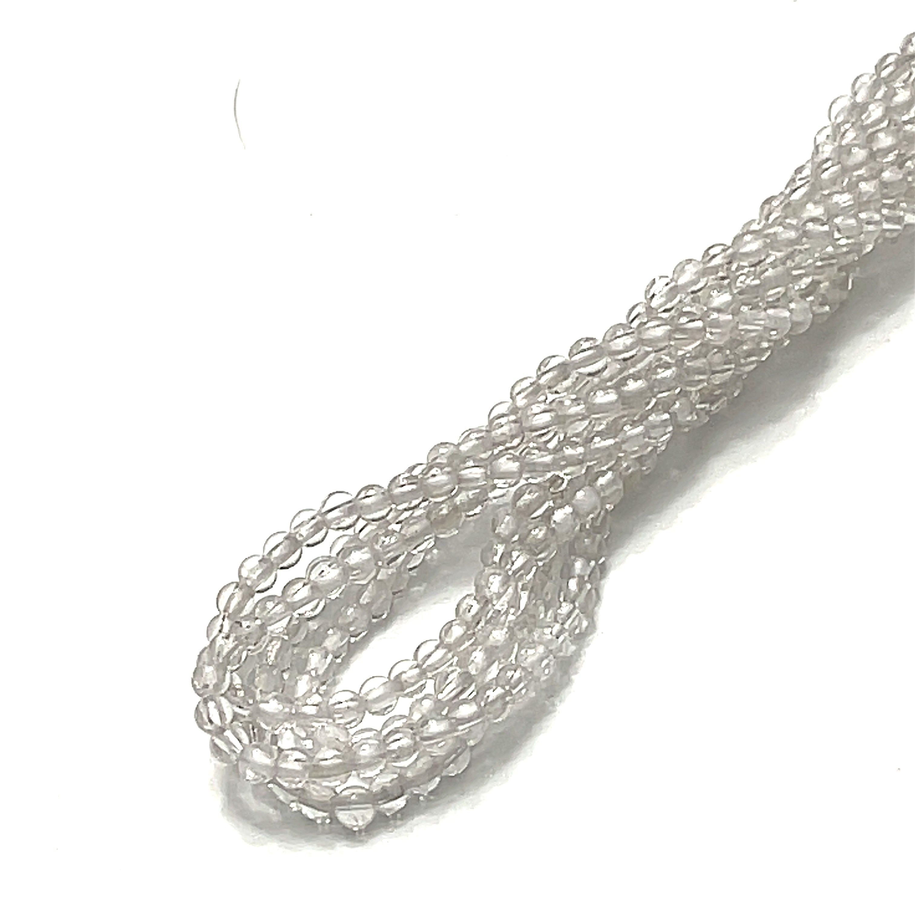 3mm Clear Quartz gemstone smooth round strand on a white background, overview. 