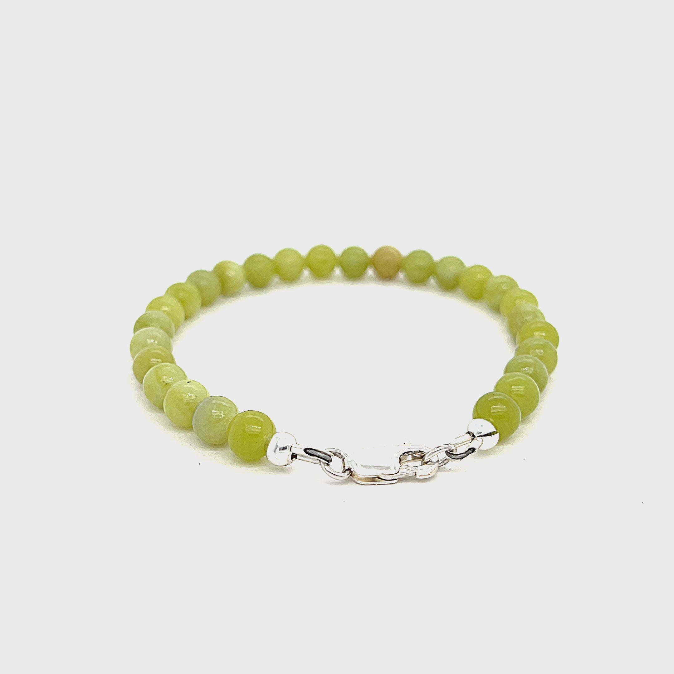 Serpentine gemstone bracelet with 6mm smooth green beads and Sterling Silver clasp from Hidden Jewel of the South End on a white background front view. video