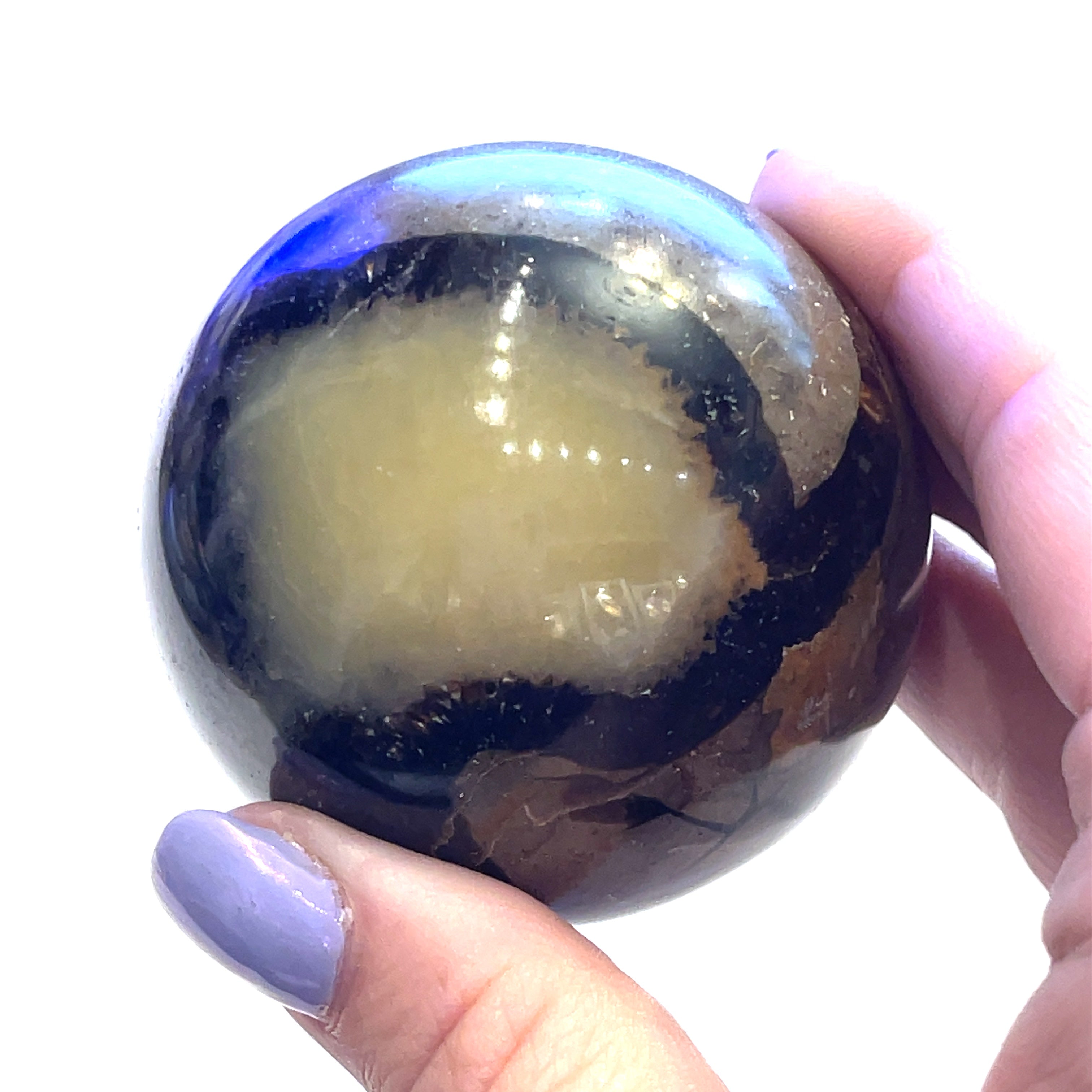 #4 A gemstone sphere displayed in a model's palm on a white background in front view.