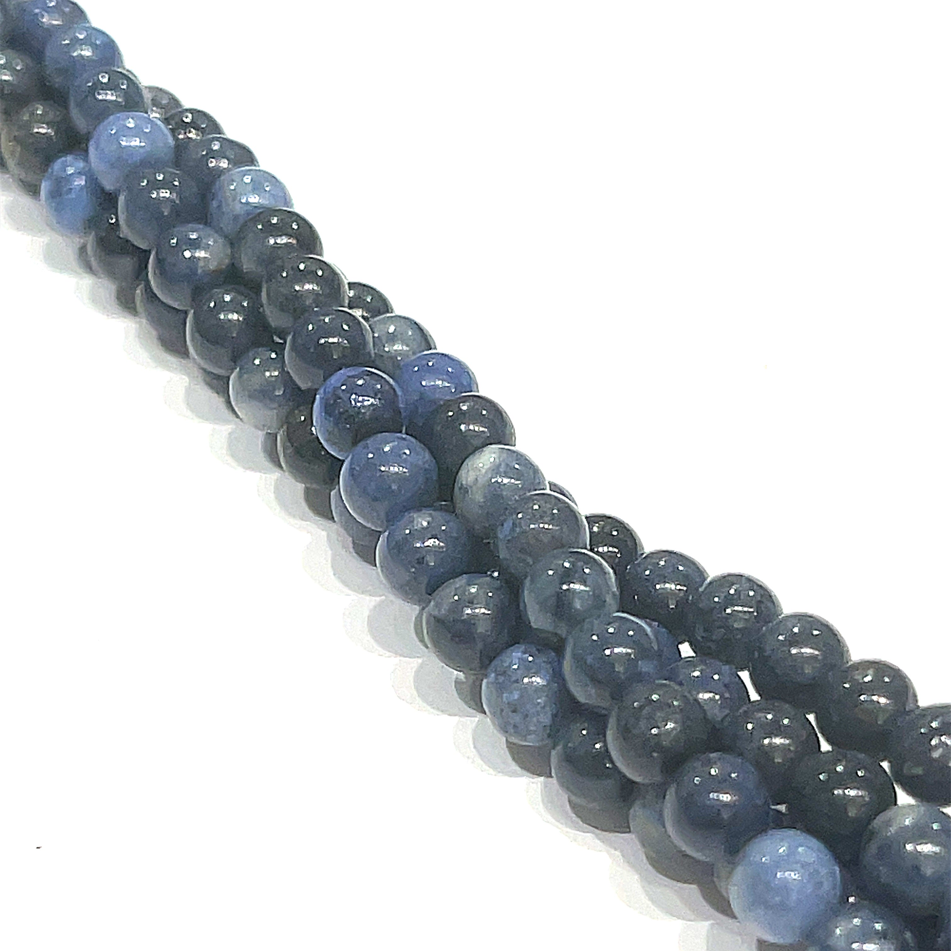 4mm Dumortierite smooth round gemstone strand, on a white background, front overview. 