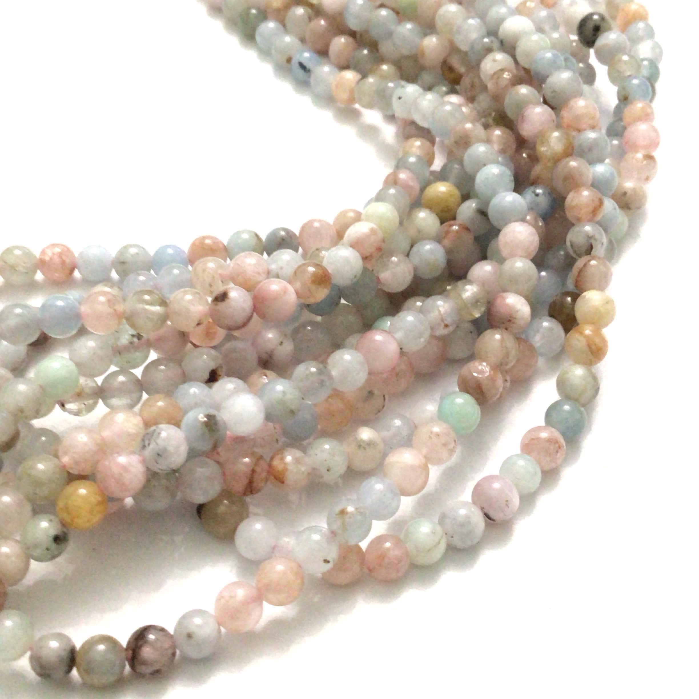 4mm Morganite gemstone strand with soft pink, blue, and  peach hues round smooth 16'' strands  on a white background, front overview.