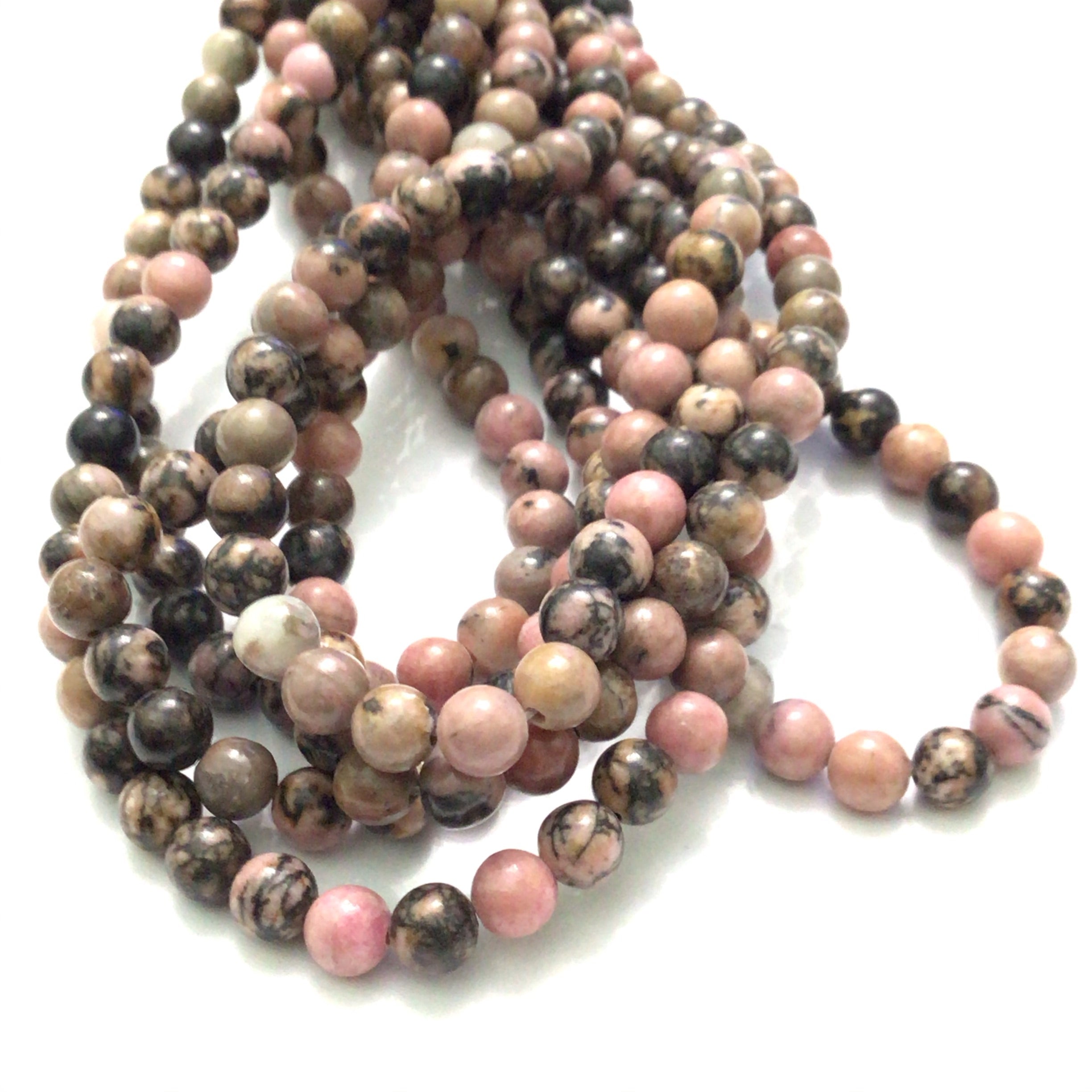 4mm Rhodonite smooth round gemstone strands, front overview. 