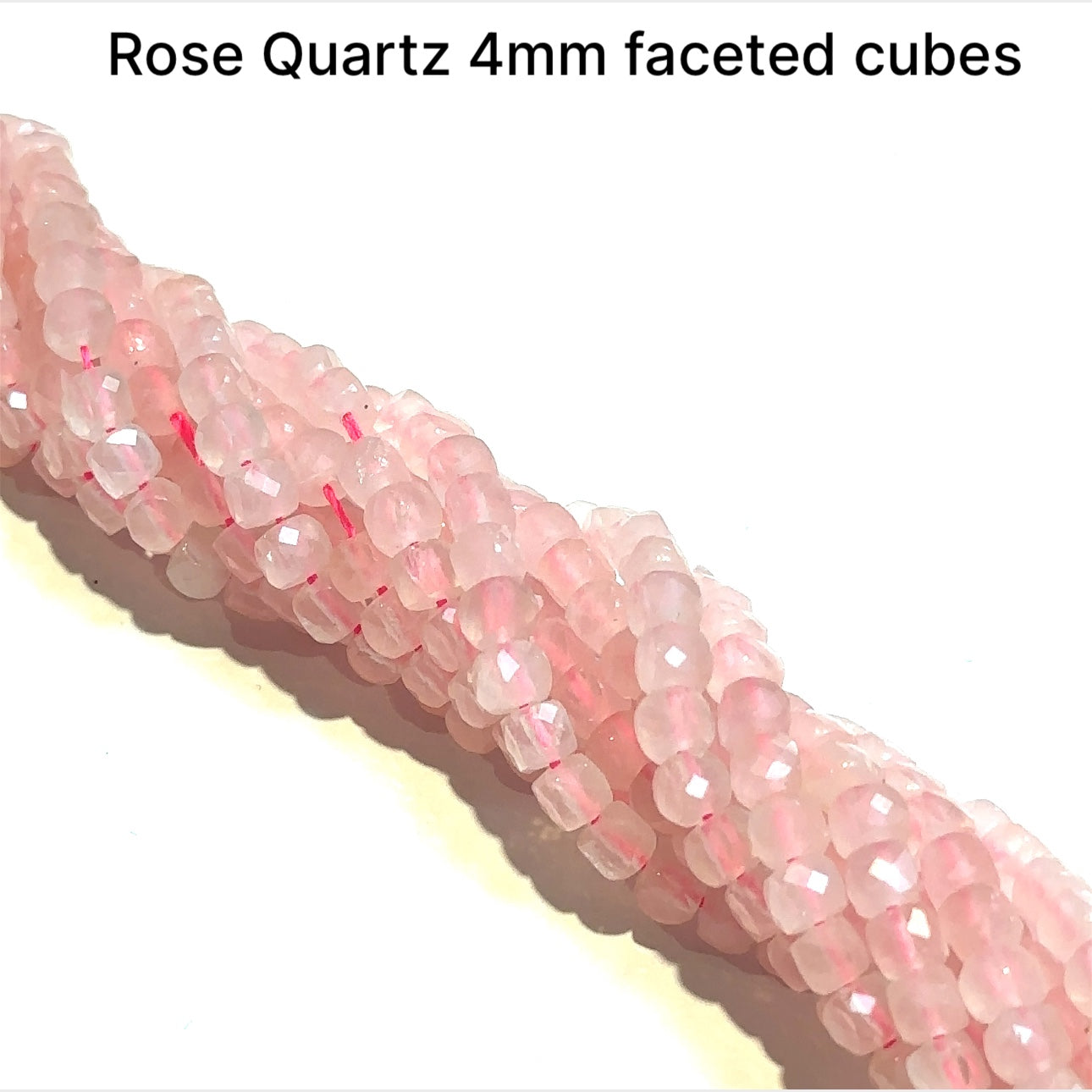 4mm  Rose Quartz gemstone beads, faceted cubes, 16'' strand on a white background, front overview.