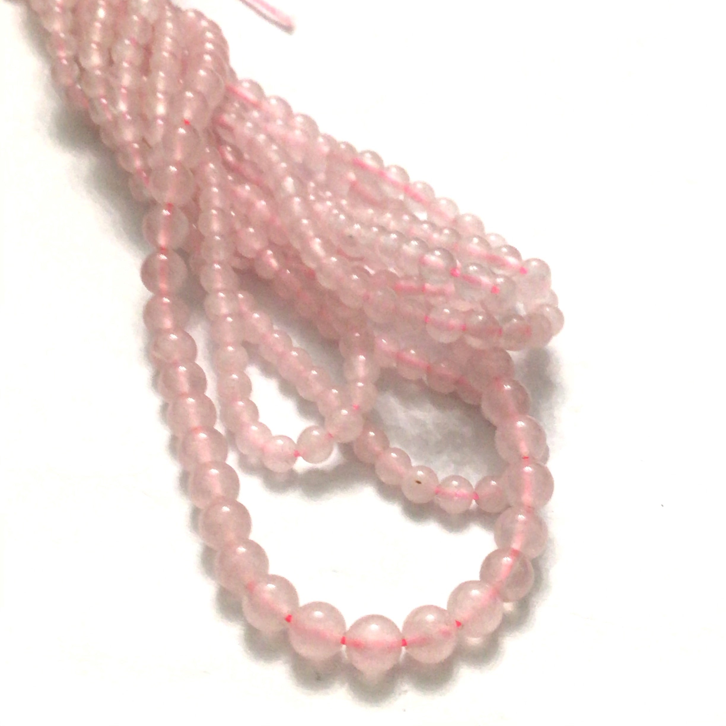 4mm Rose Quartz gemstone beads, smooth round, 16'' strand on a white background, front overview.