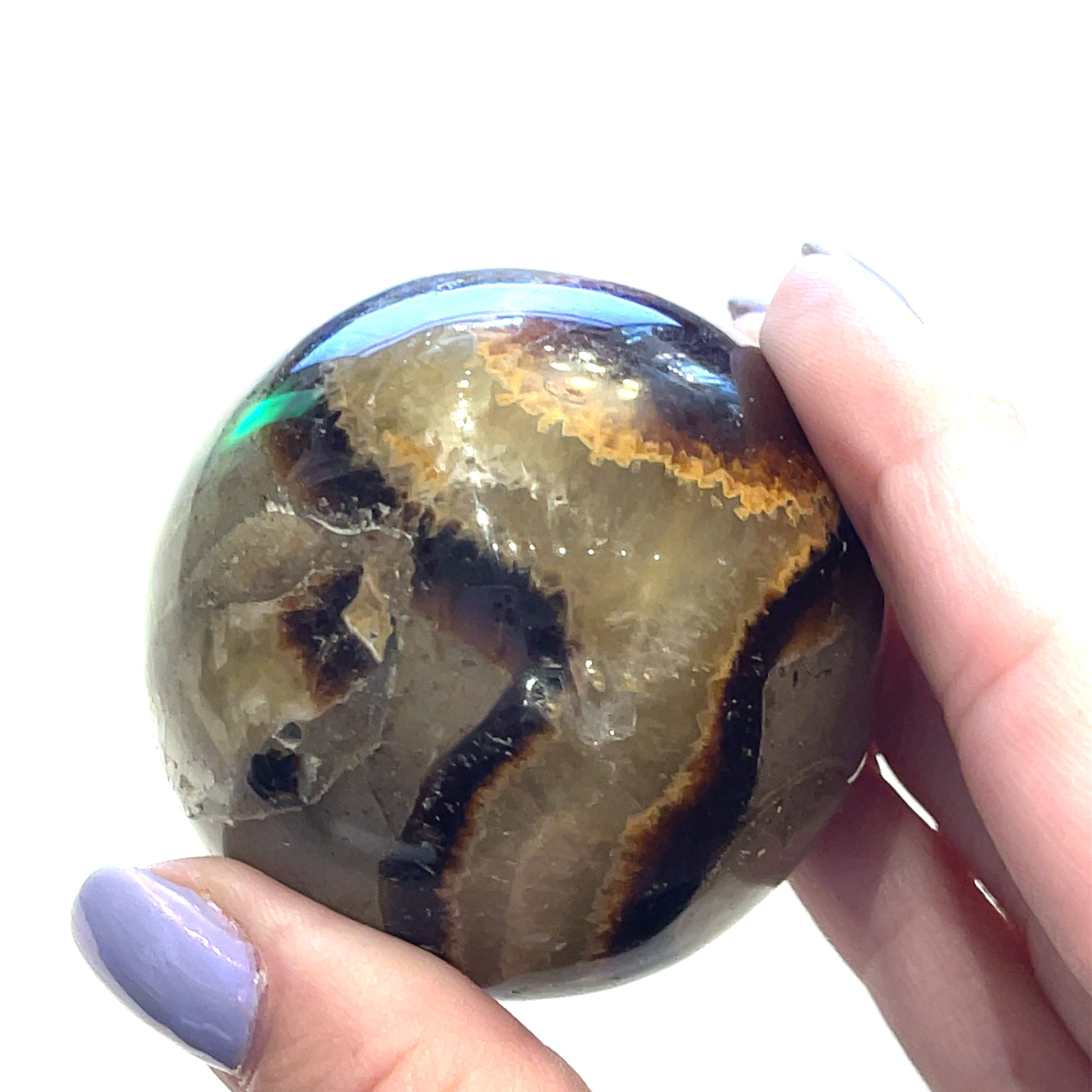 #5 A gemstone sphere displayed in a model's palm on a white background in front view.
