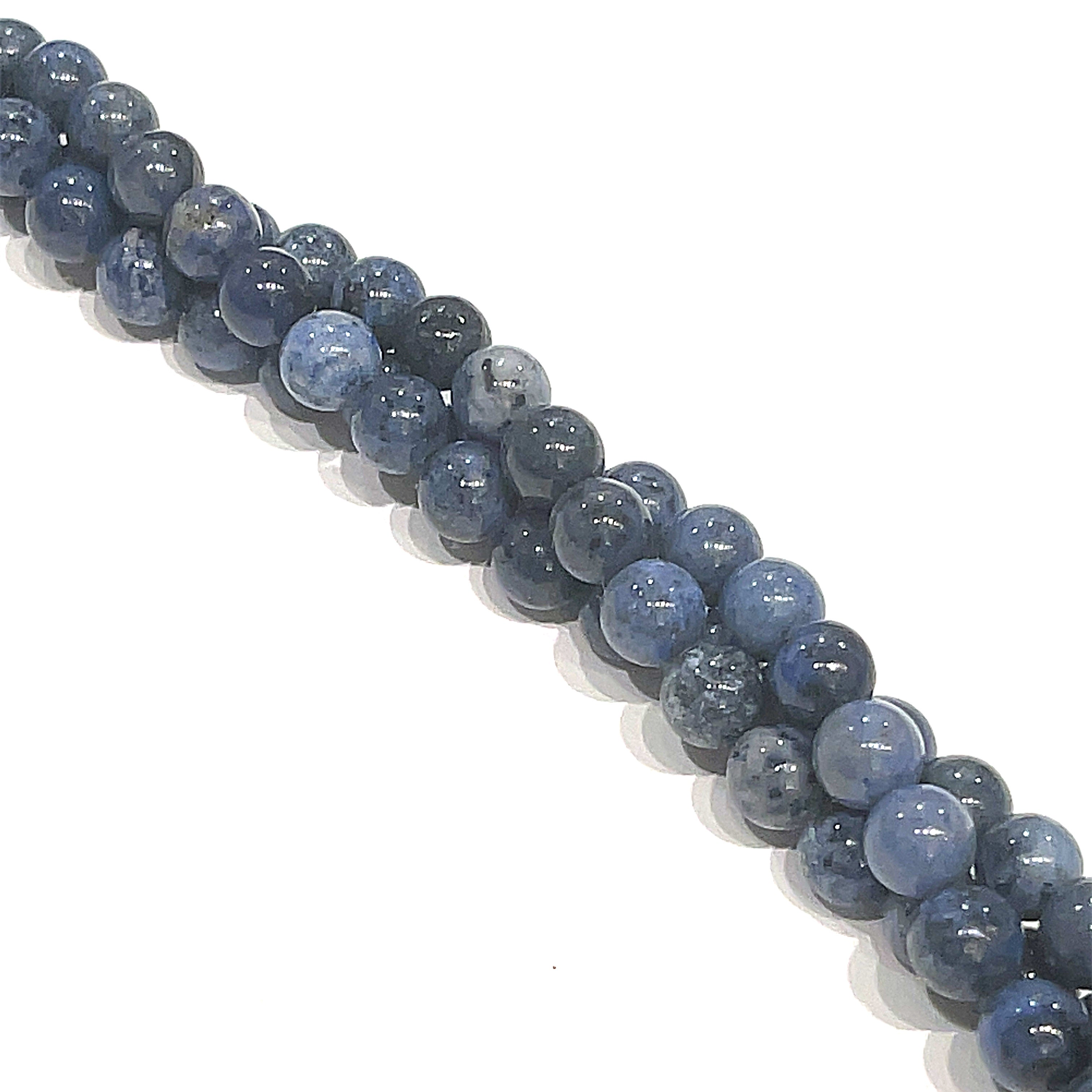 5mm Dumortierite smooth round gemstone strand, on a white background, front overview. 