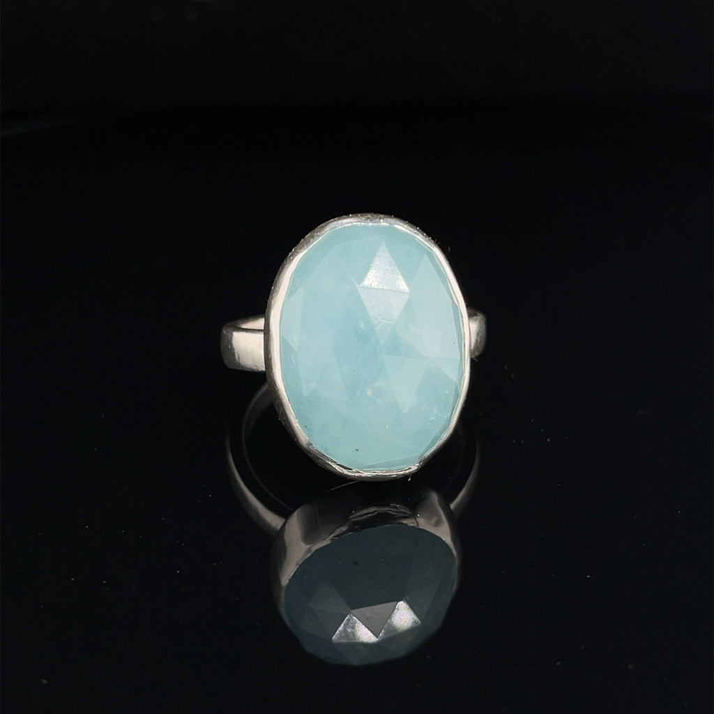 6ct faceted Aquamarine sterling silver ring — March birthstone jewelry on a black background front view. 