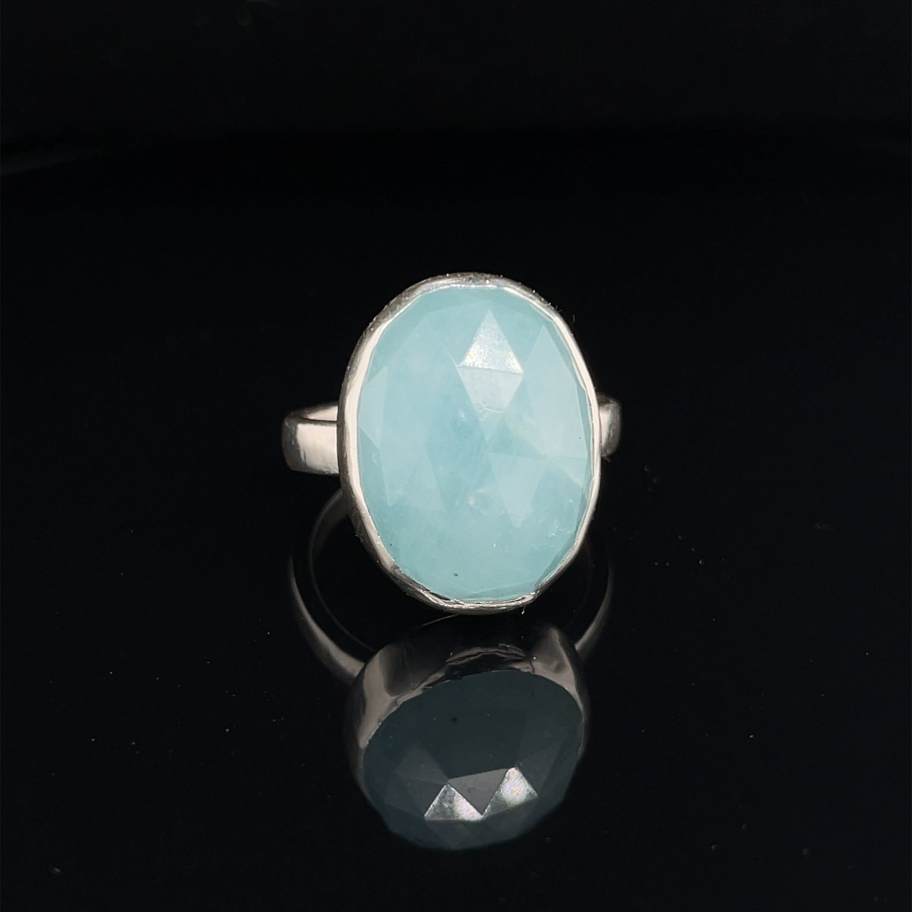 6ct faceted Aquamarine sterling silver ring — March birthstone jewelry on a black background front view. 
