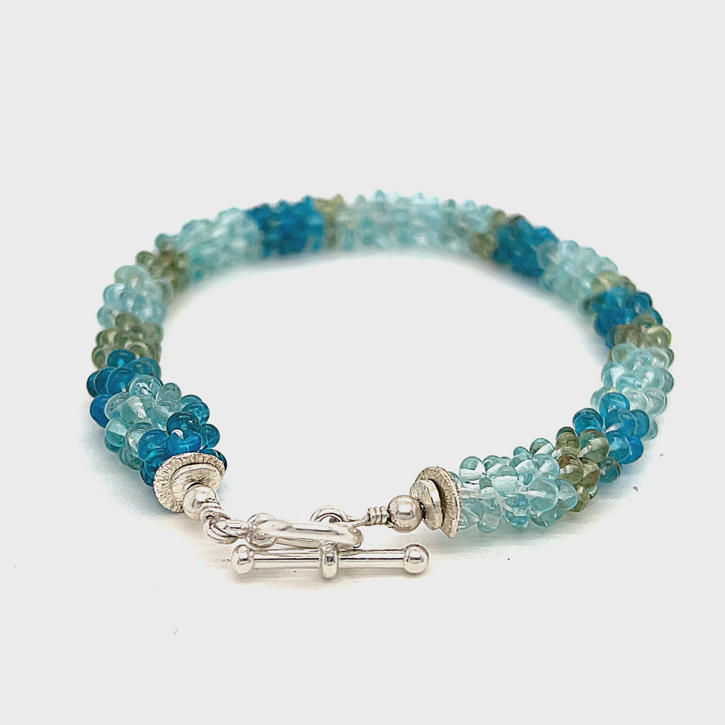 Handcrafted Fluorite gemstone bracelet with sterling silver toggle on a white background, front overview. video
