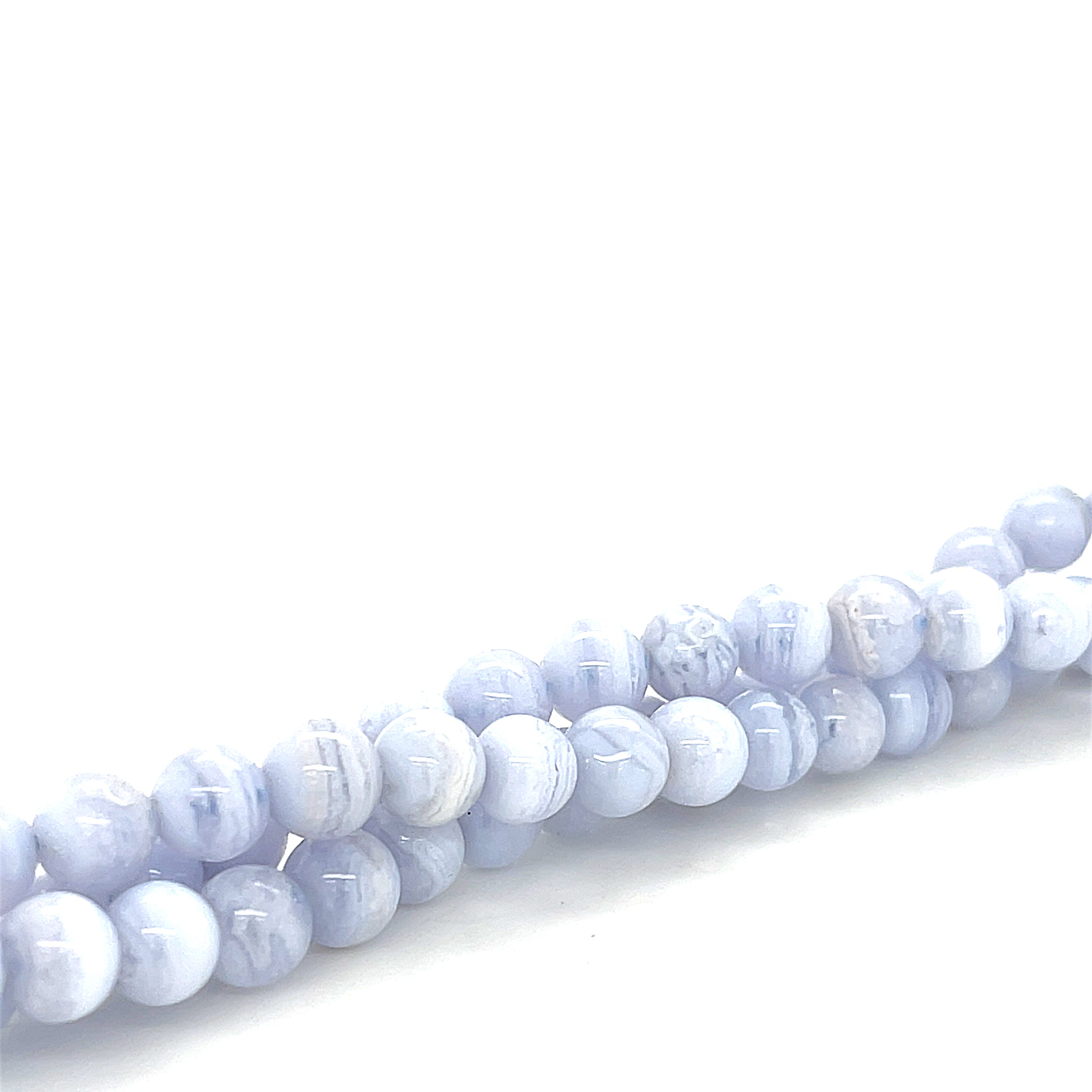 6mm Blue lace Agate round gemstones on a white background, front overview. 
