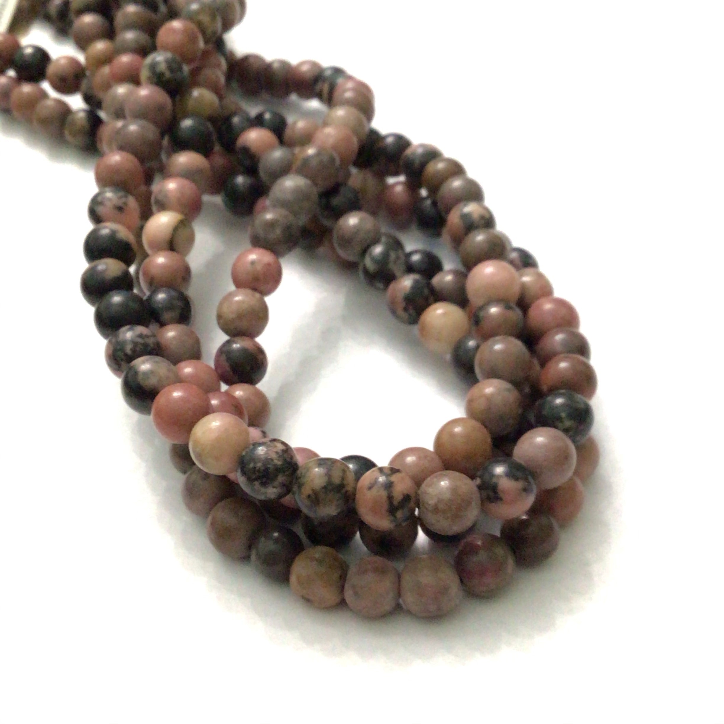 6mm Rhodonite smooth round gemstone strands, front overview. 