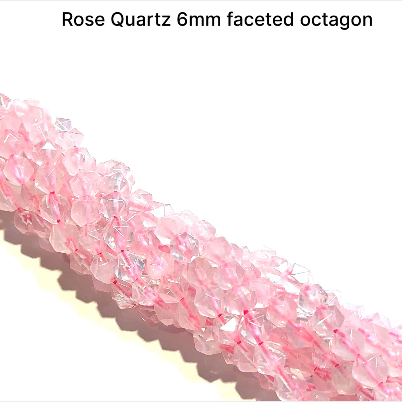 6mm  Rose Quartz gemstone beads, faceted octagon, 16'' strand on a white background, front overview.