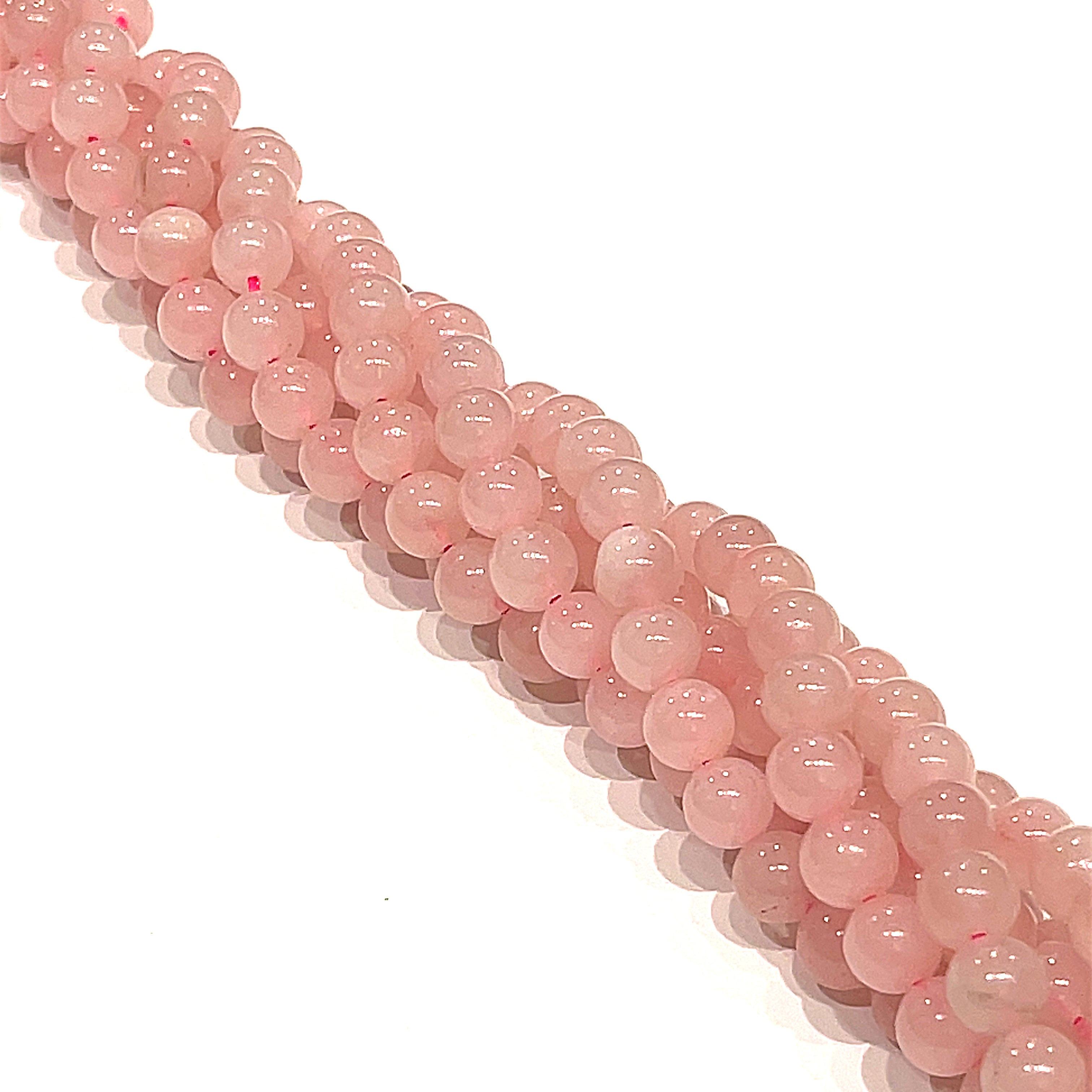 6mm  Rose Quartz gemstone beads, smooth round, 16'' strand on a white background, overview.