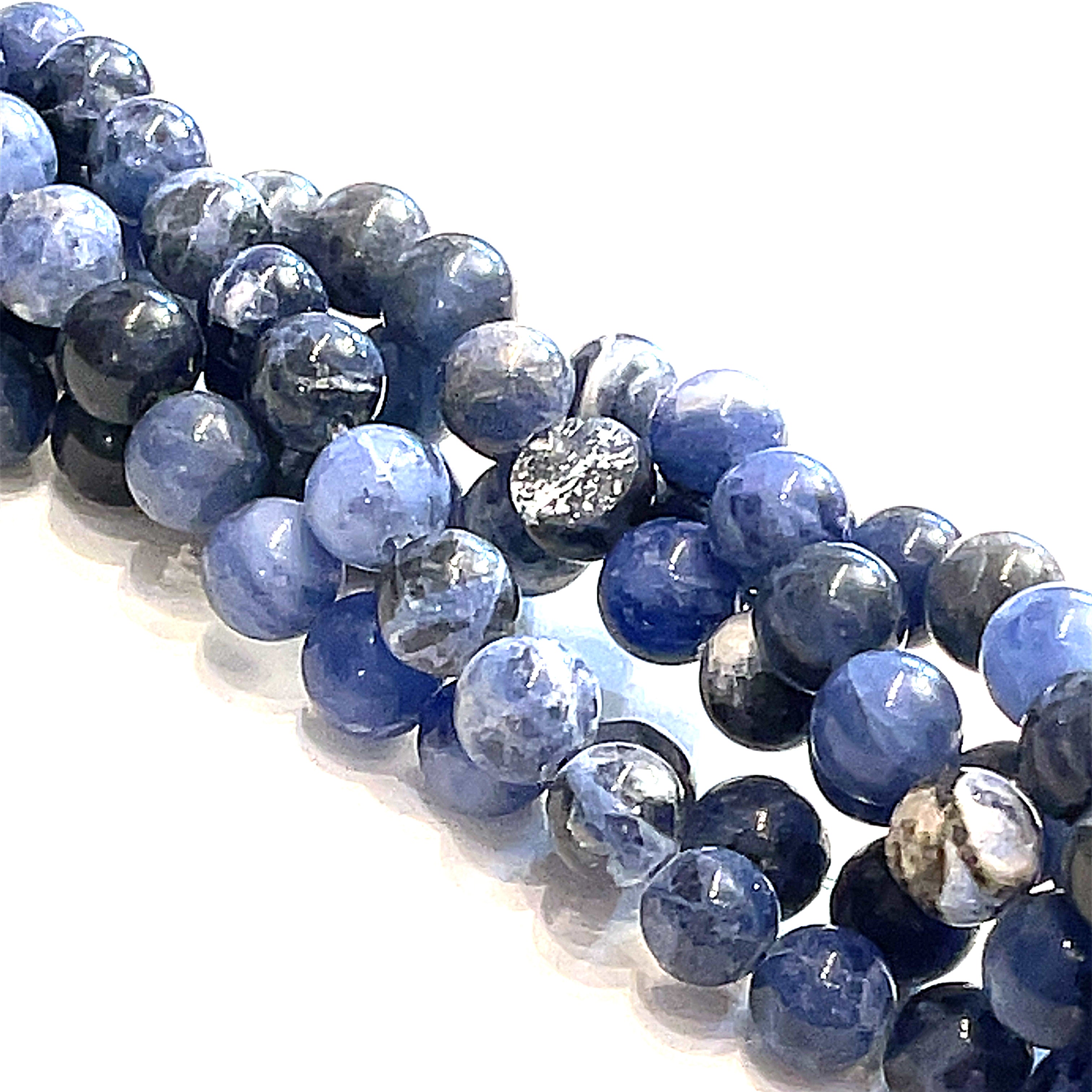 6mm Sodalite smooth round gemstone strand on a white background, front close up  overview.