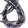 6mm smooth round Natural iolite gemstone strand in deep blue for third eye chakra activation and intuition on a white background, front over view. 