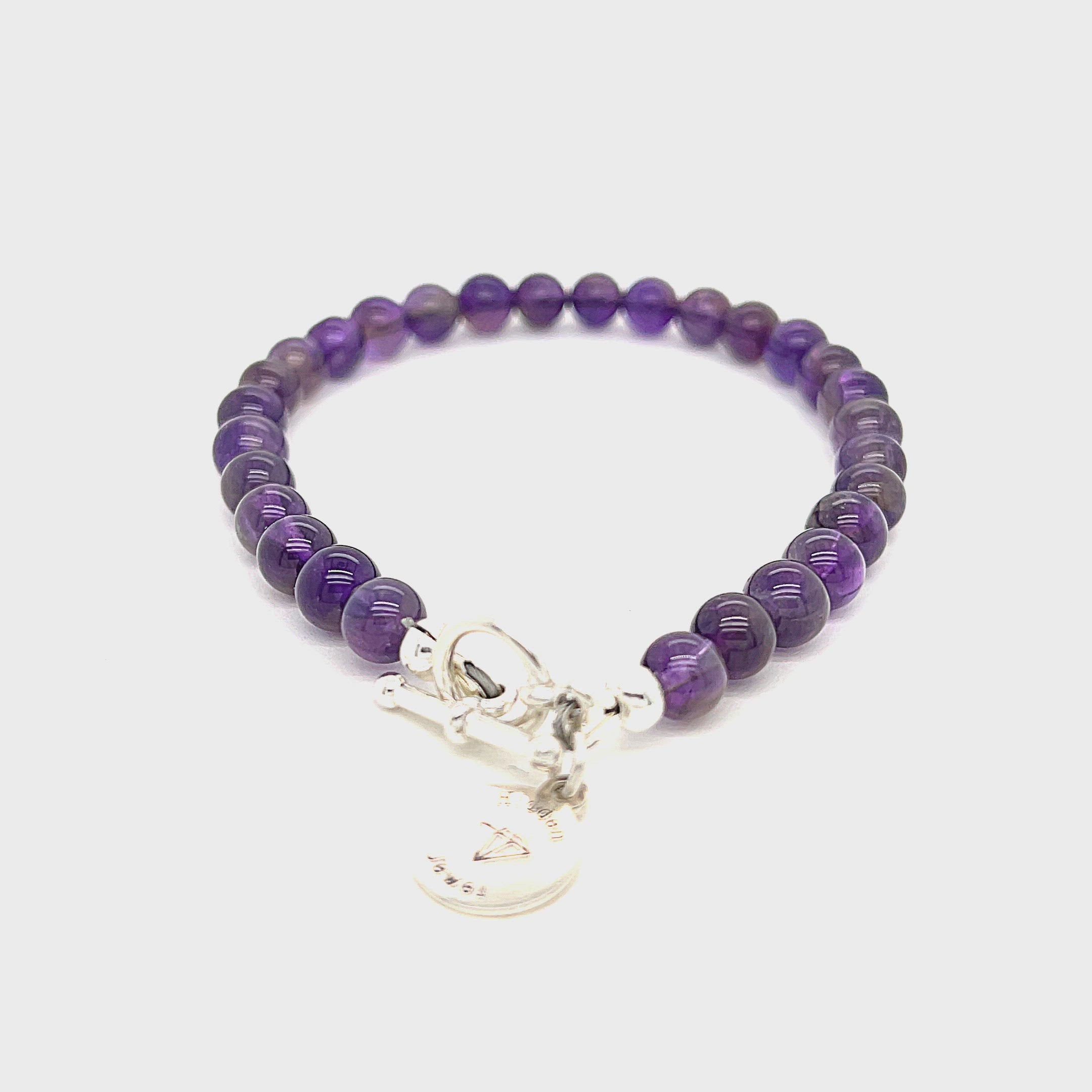 A beaded Amethyst gemstone bracelets, displayed against a white background, toggle overview. video
