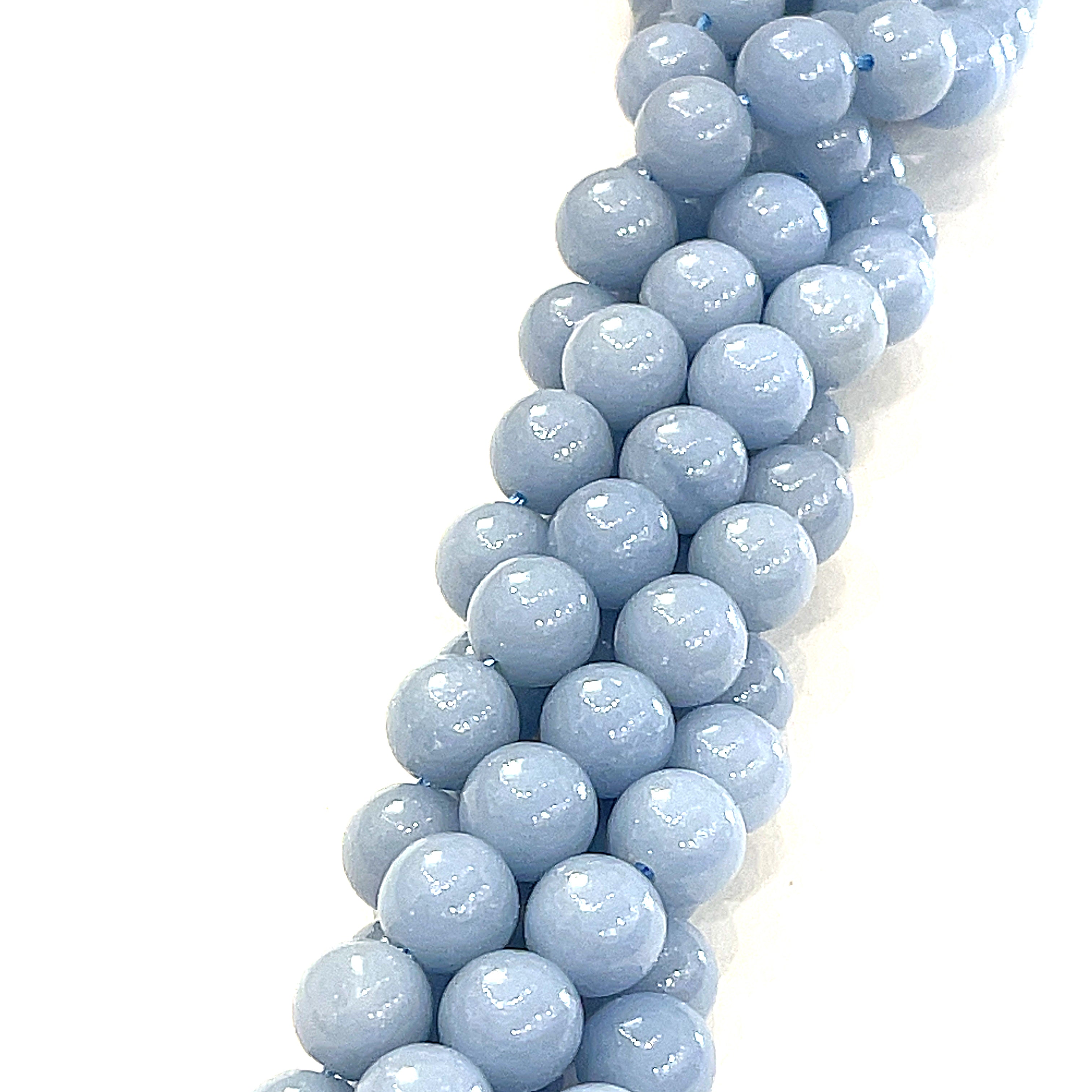 8mm Angelite smooth round gemstone strand, on a white background, front view. 