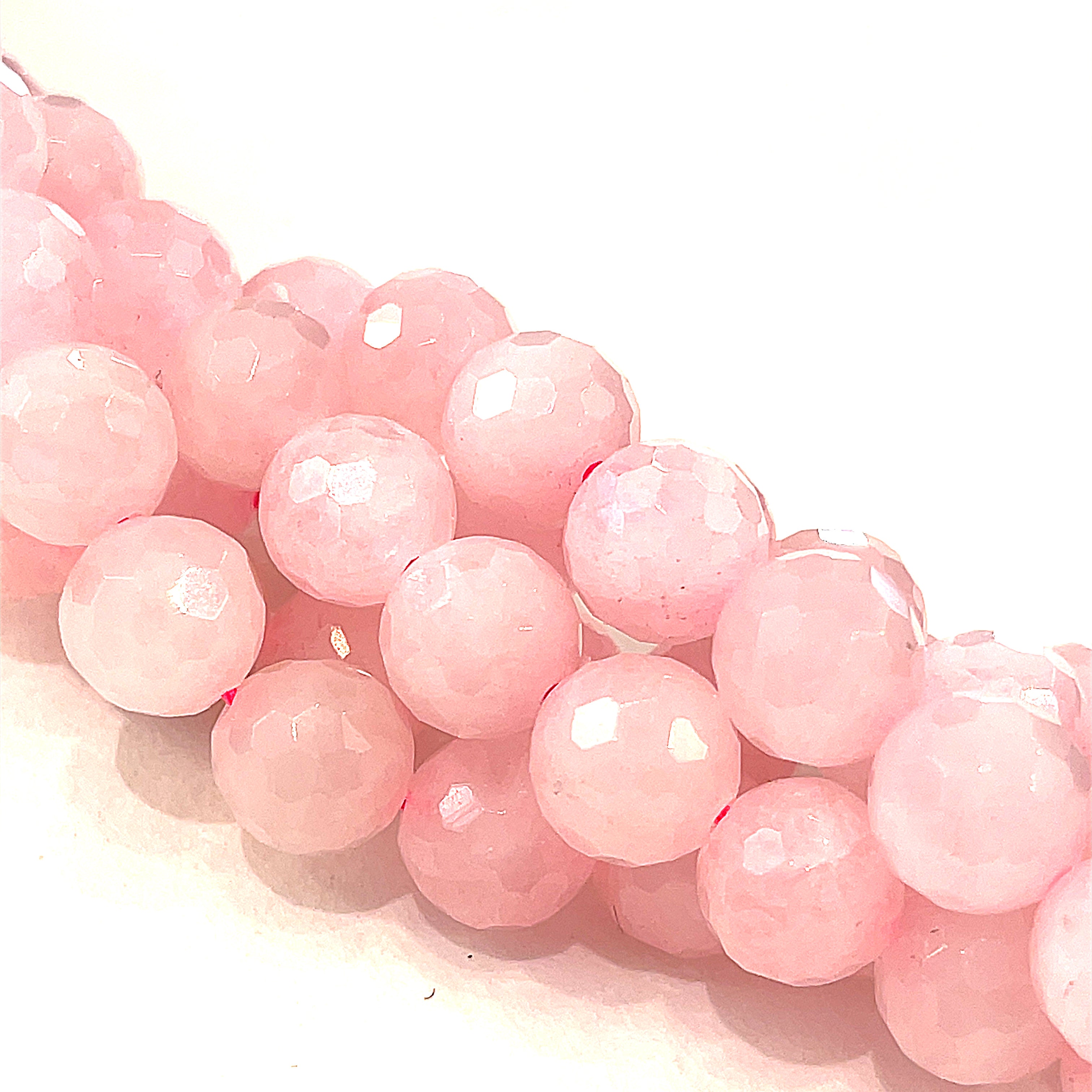 8mm  Rose Quartz gemstone beads, faceted round, 16'' strand on a white background, front overview.