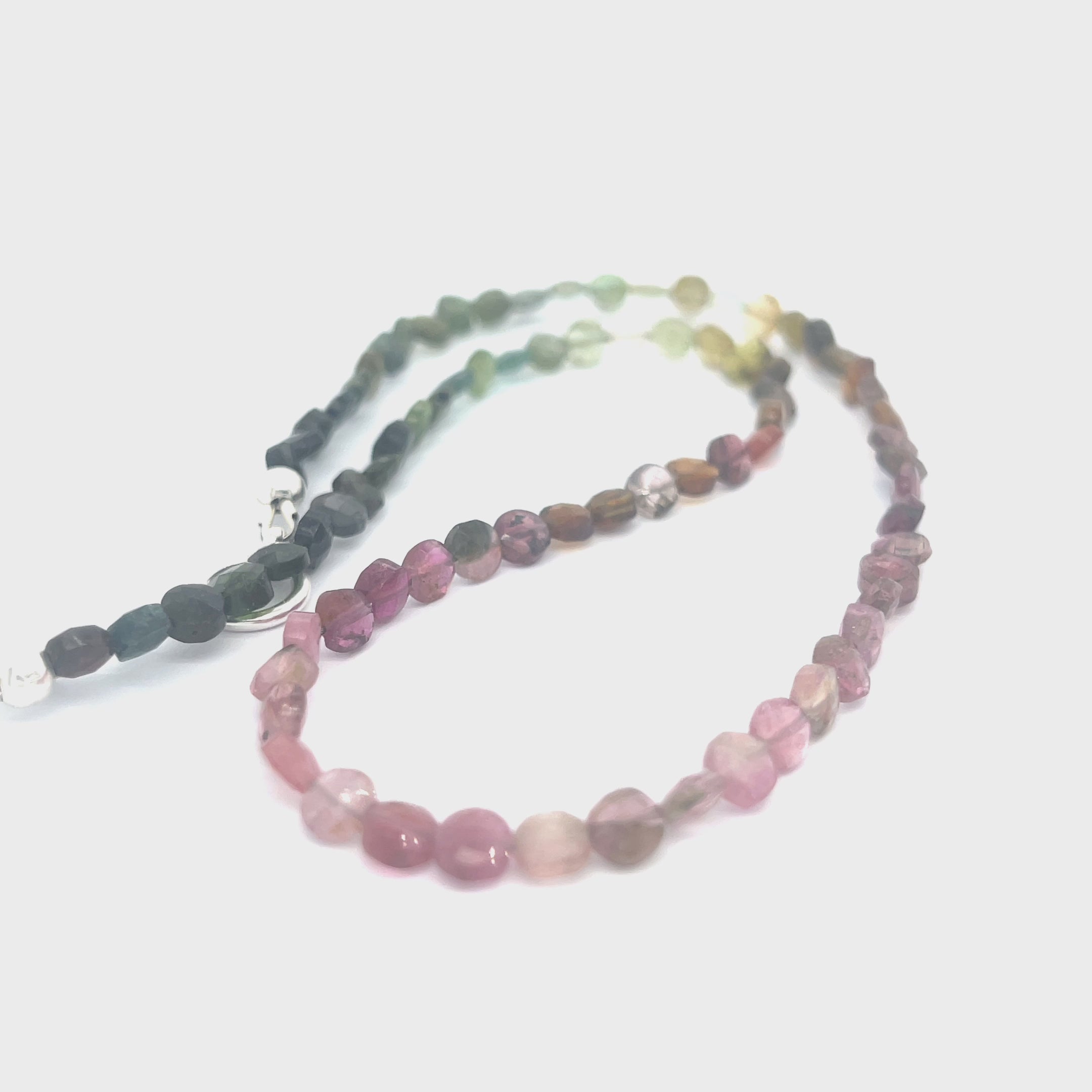 Handcrafted Watermelon Tourmaline gemstone necklace with sterling silver accents by Hidden Jewel on a white background center long overview.  video