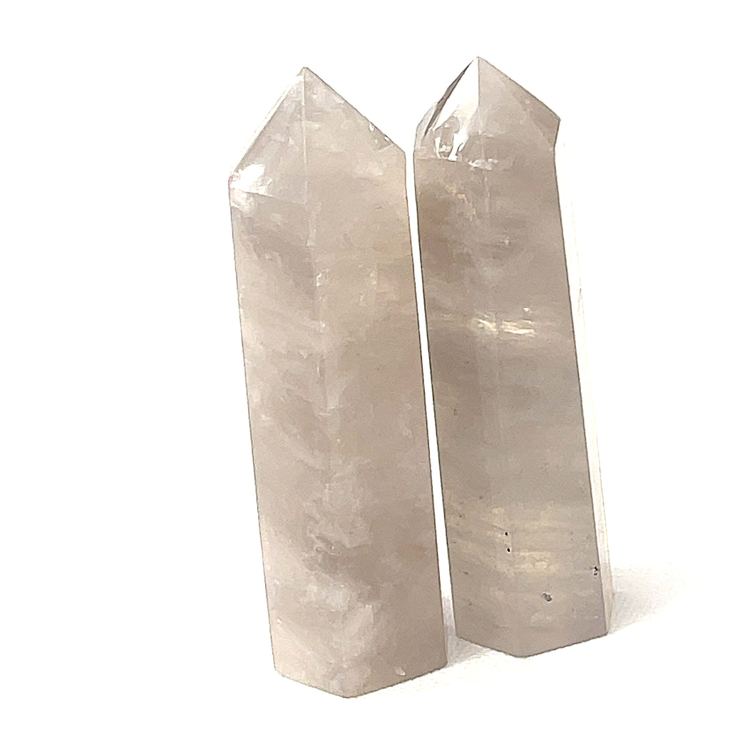 A  Blue Rose quartz gemstone towers arranged together on a white background, front overview. 