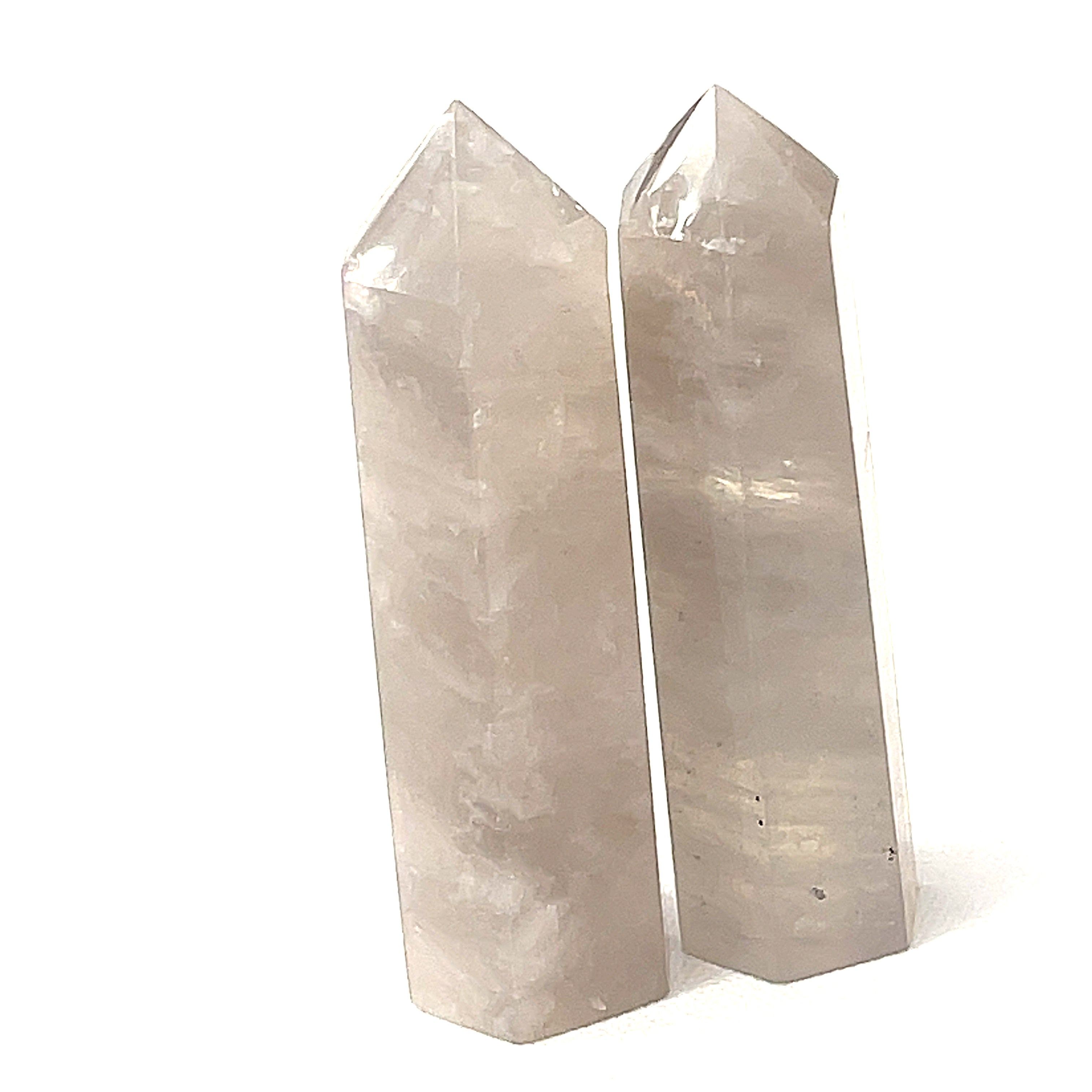A  Blue Rose quartz gemstone towers arranged together on a white background, front overview. 
