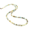 A Burma Jade gemstone beaded necklace with a silver lobster claw closure, displayed on a white background, long, front overview. 