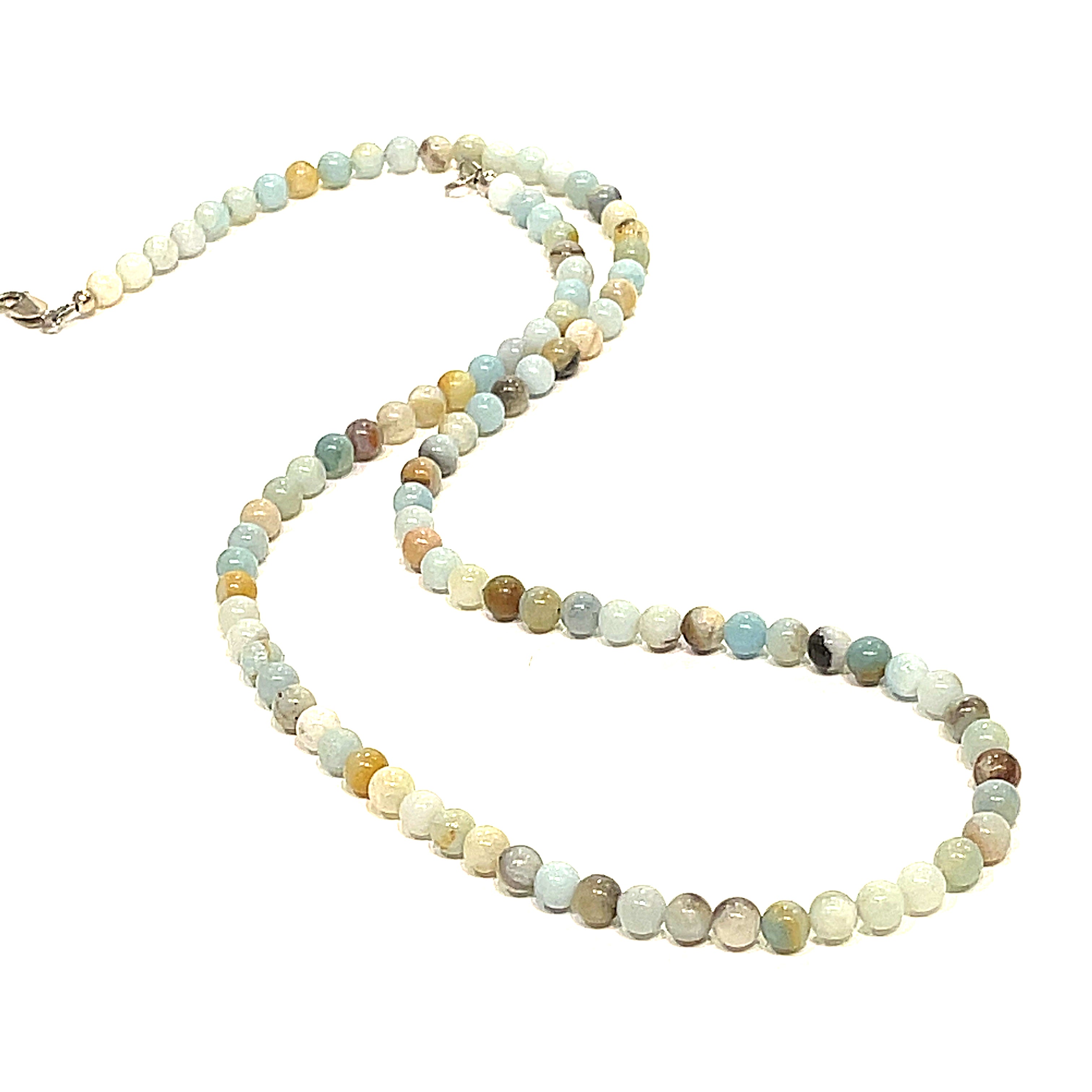 A Burma Jade gemstone beaded necklace with a silver lobster claw closure, displayed on a white background, long, front overview. 
