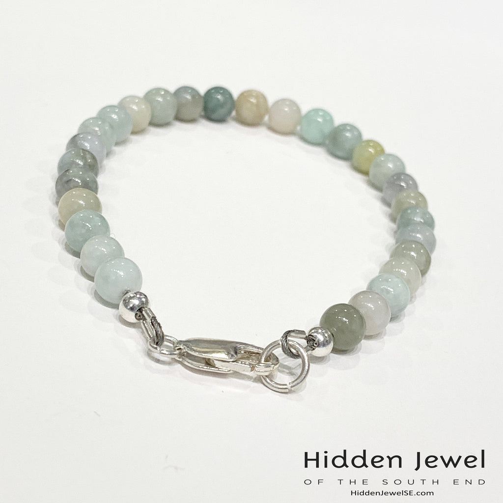 A Burma jade gemstone beaded bracelet with sterling silver  lobster claw on white background, back  angle overview. 