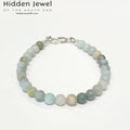 A Burma jade gemstone beaded bracelet with sterling silver  lobster claw on white background, front close up overview. 