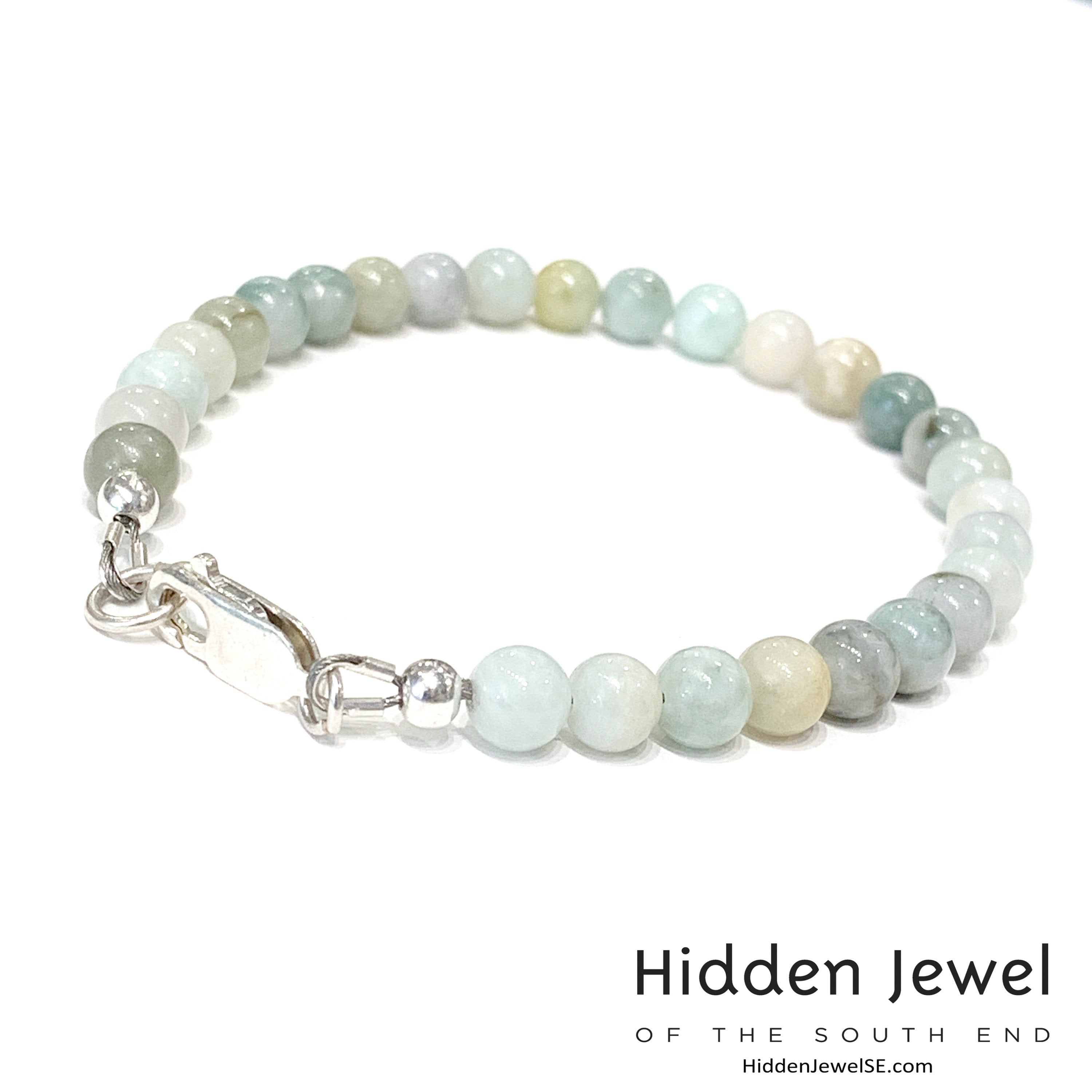 A Burma jade gemstone beaded bracelet with sterling silver  lobster claw on white background, front left angle overview. 