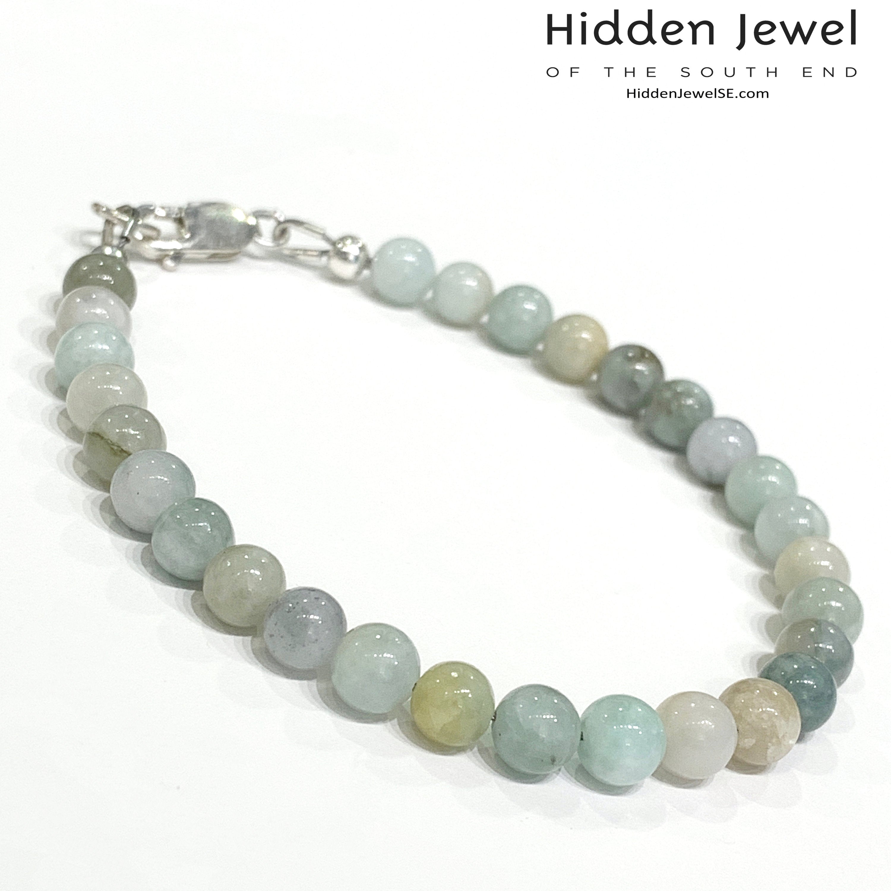 A Burma jade gemstone beaded bracelet with sterling silver  lobster claw on white background, front right angle overview. 