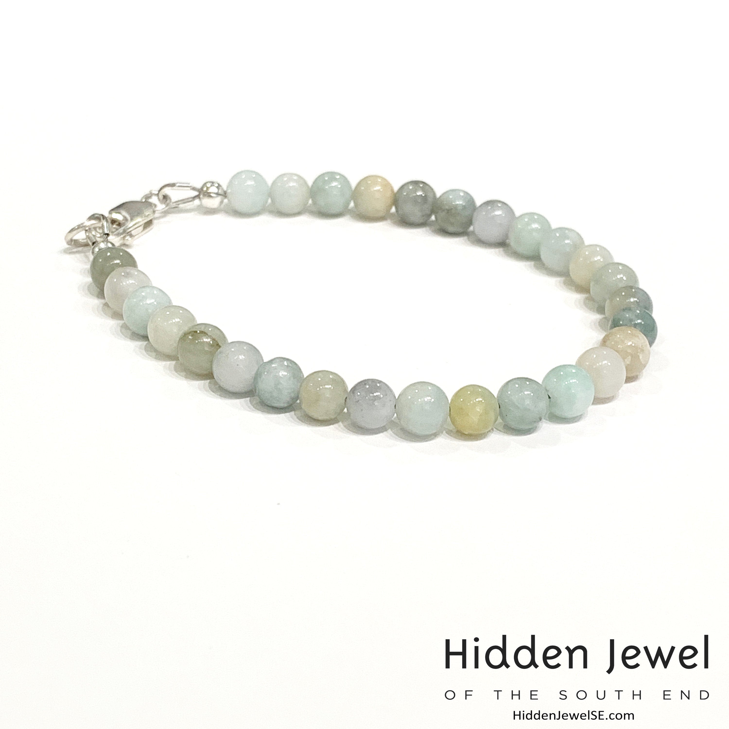 A Burma jade gemstone beaded bracelet with sterling silver  lobster claw on white background, right side angle overview. 