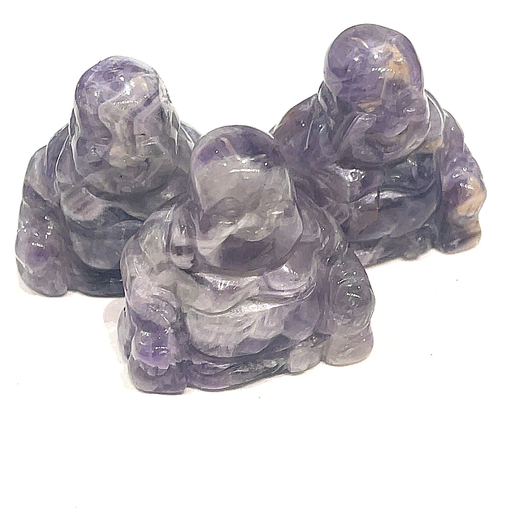 A Close-up of Amethyst  Reiki infused gemstone Buddha with detailed carving on a white background front overview. 