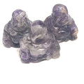 A Close-up of Amethyst  Reiki infused gemstone Buddha with detailed carving on a white background front overview. 