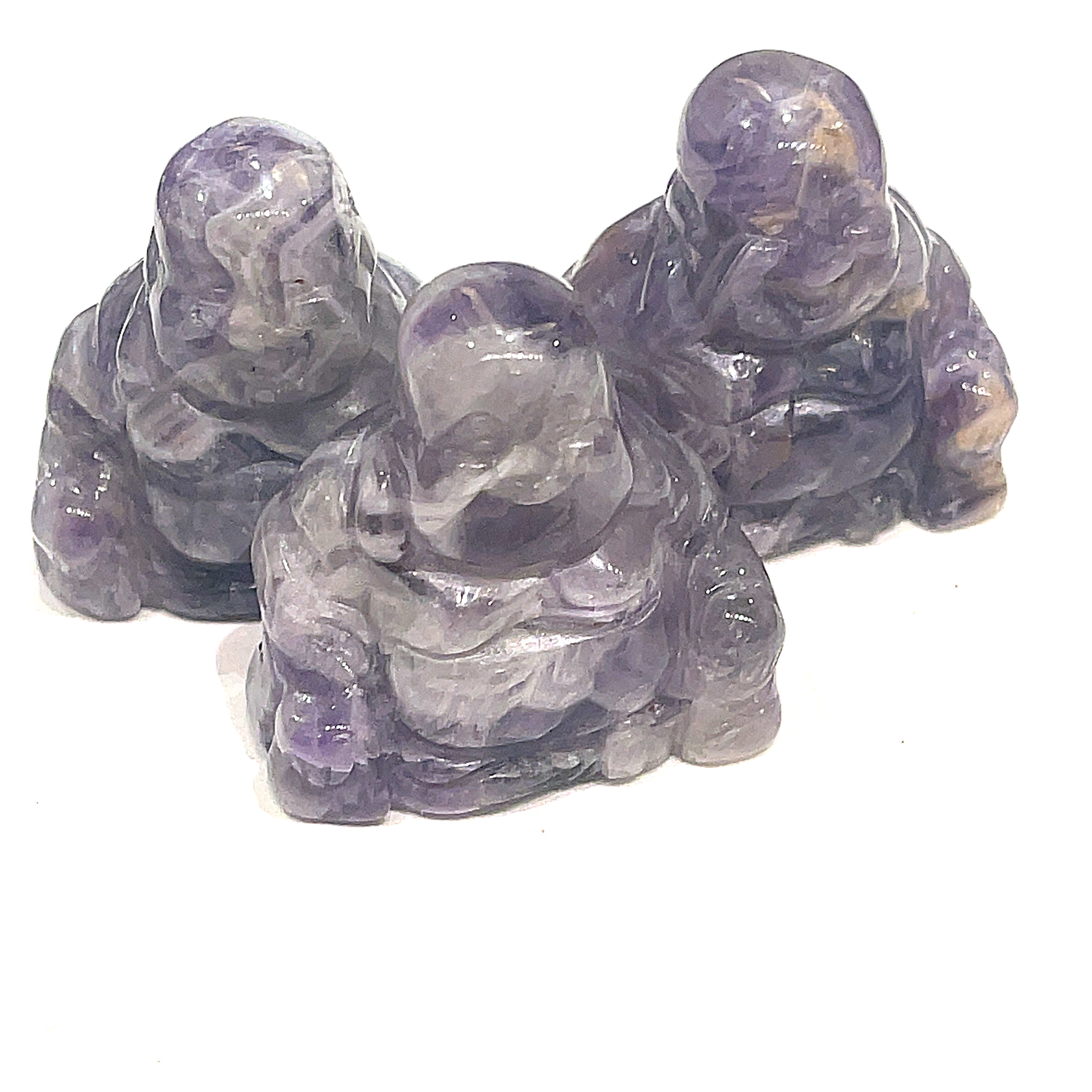 A Close-up of Amethyst  Reiki infused gemstone Buddha with detailed carving on a white background front overview. 