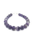 A Close-up view of polished Amegreen gemstone beads in soft lavender and green tones, handcrafted healing bracelet front overview.