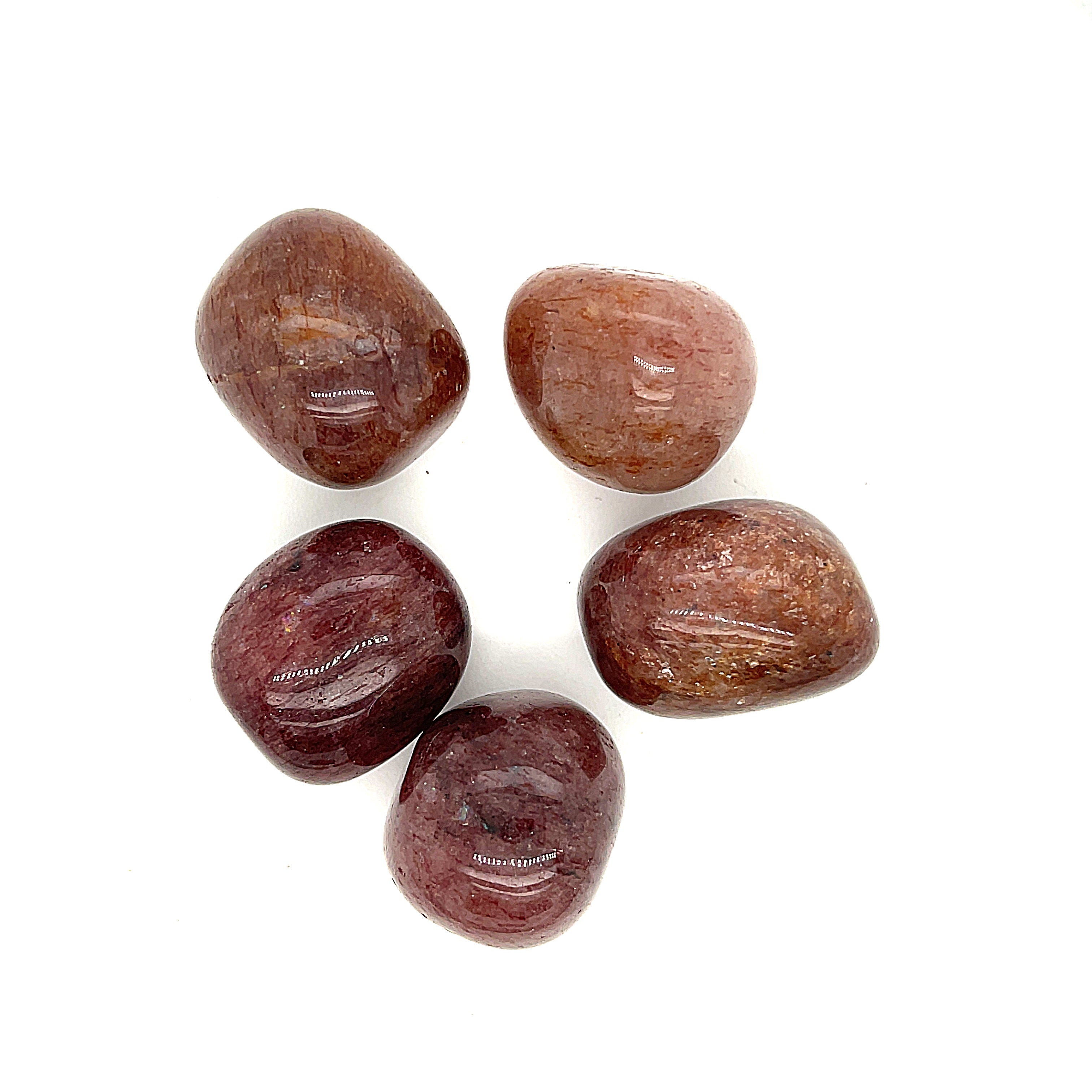 A Muscovite tumbled gemstones on a white background, overview.