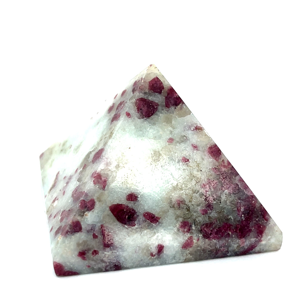 A Pink Tourmaline Pyramid used for heart chakra meditation and energy healing on a white background a close up view.