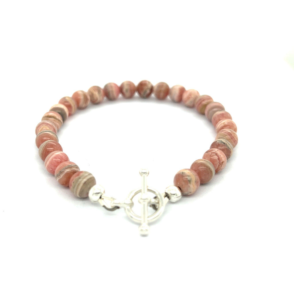 A Rhodochrosite Gemstone 6mm roundel beaded bracelet with a sterling silver toggle, on a white background, back overview.
