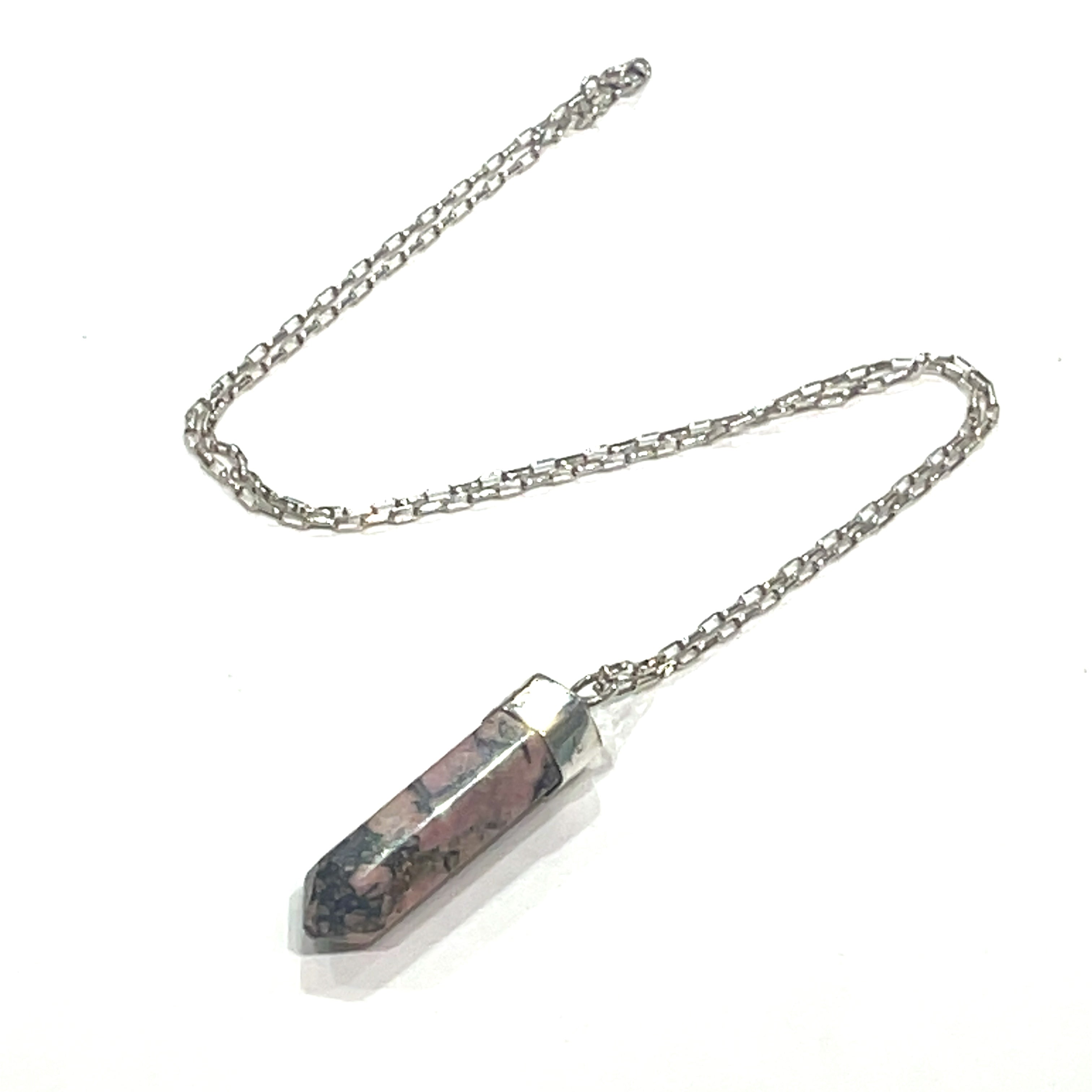 A Rhodonite gemstone pendant on a sterling silver chain. On a white background and center,  close up overview. 