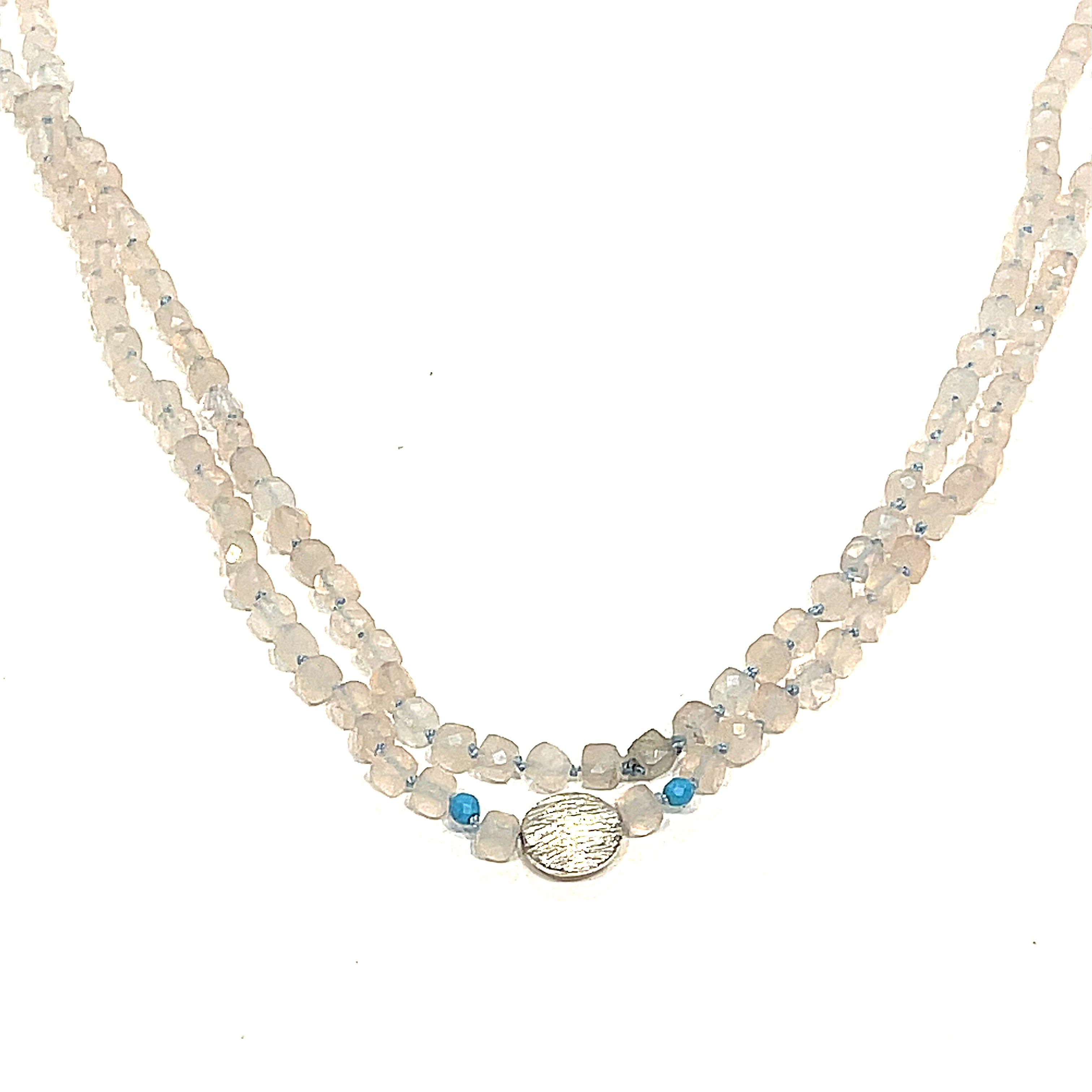 A Rose Quartz and Turquoise knotted necklace with sterling silver beads, on a white background, front, long, hanging close-up overview. 