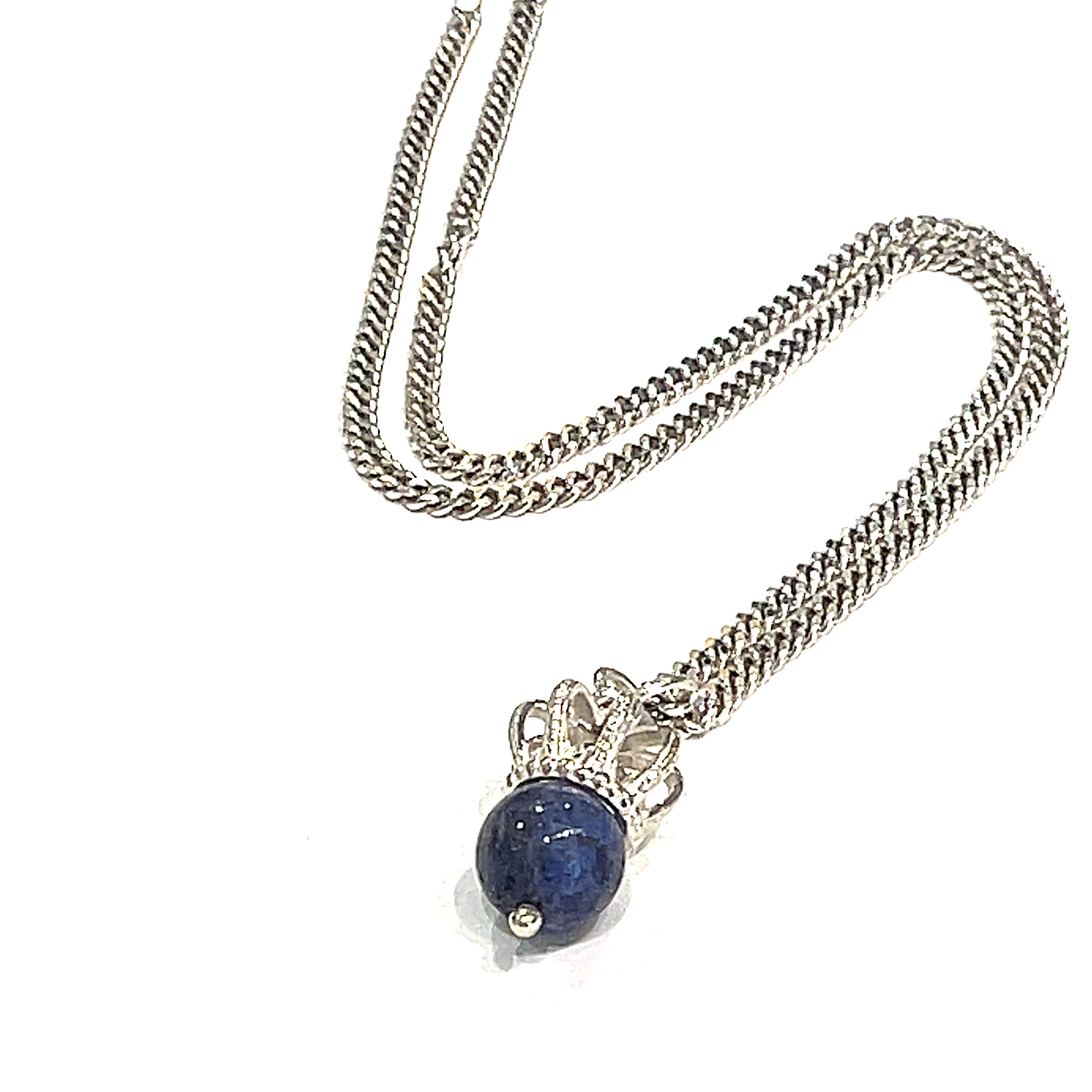 A Sterling Silver Crown Pendant with lapis lazuli gemstone on a white background, diagonal long overview. 