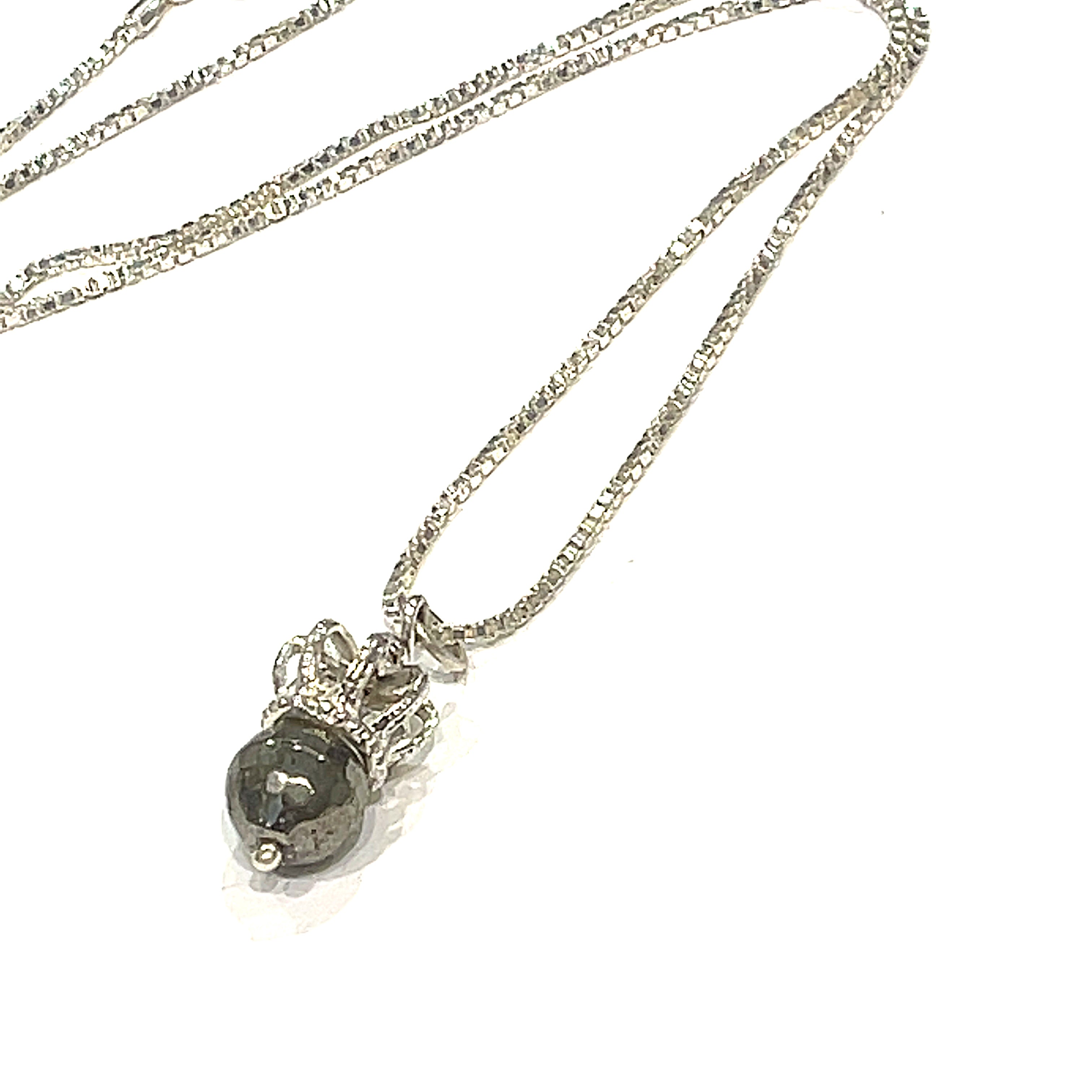 A Sterling Silver Crown Pendant with pyrite gemstone on a white background, diagonal long overview. 