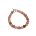 A Thulite gemstone bracelets with Sterling Silver findings and a Sterling Silver toggle, displayed against a white background, front clpose up overview.